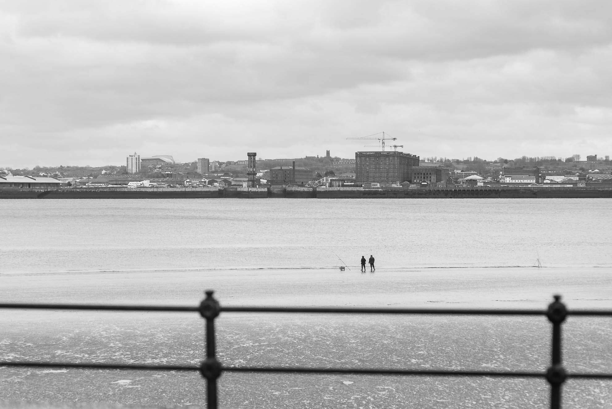 2 men fishing in Mersey river