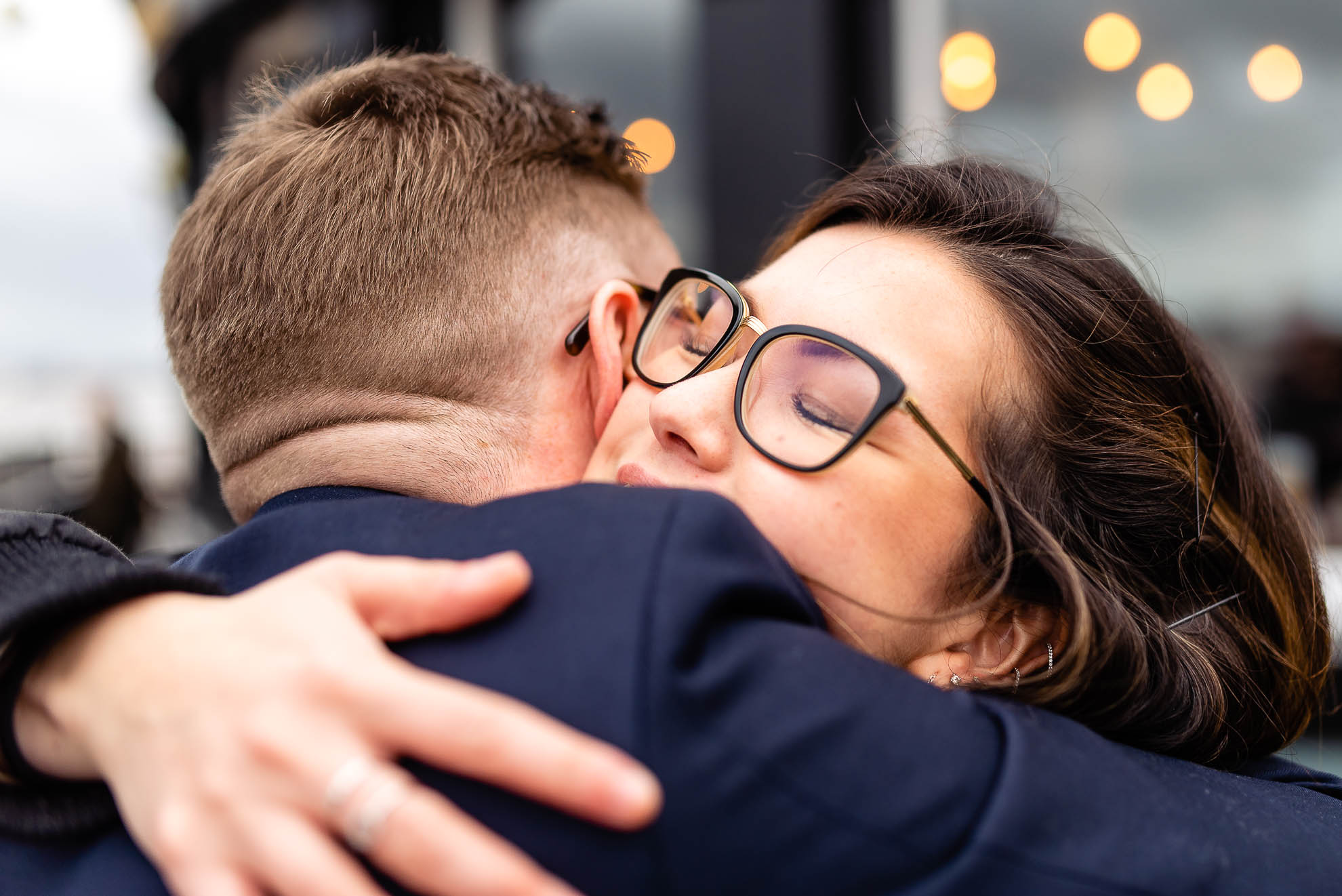 Groom hugs wedding guest