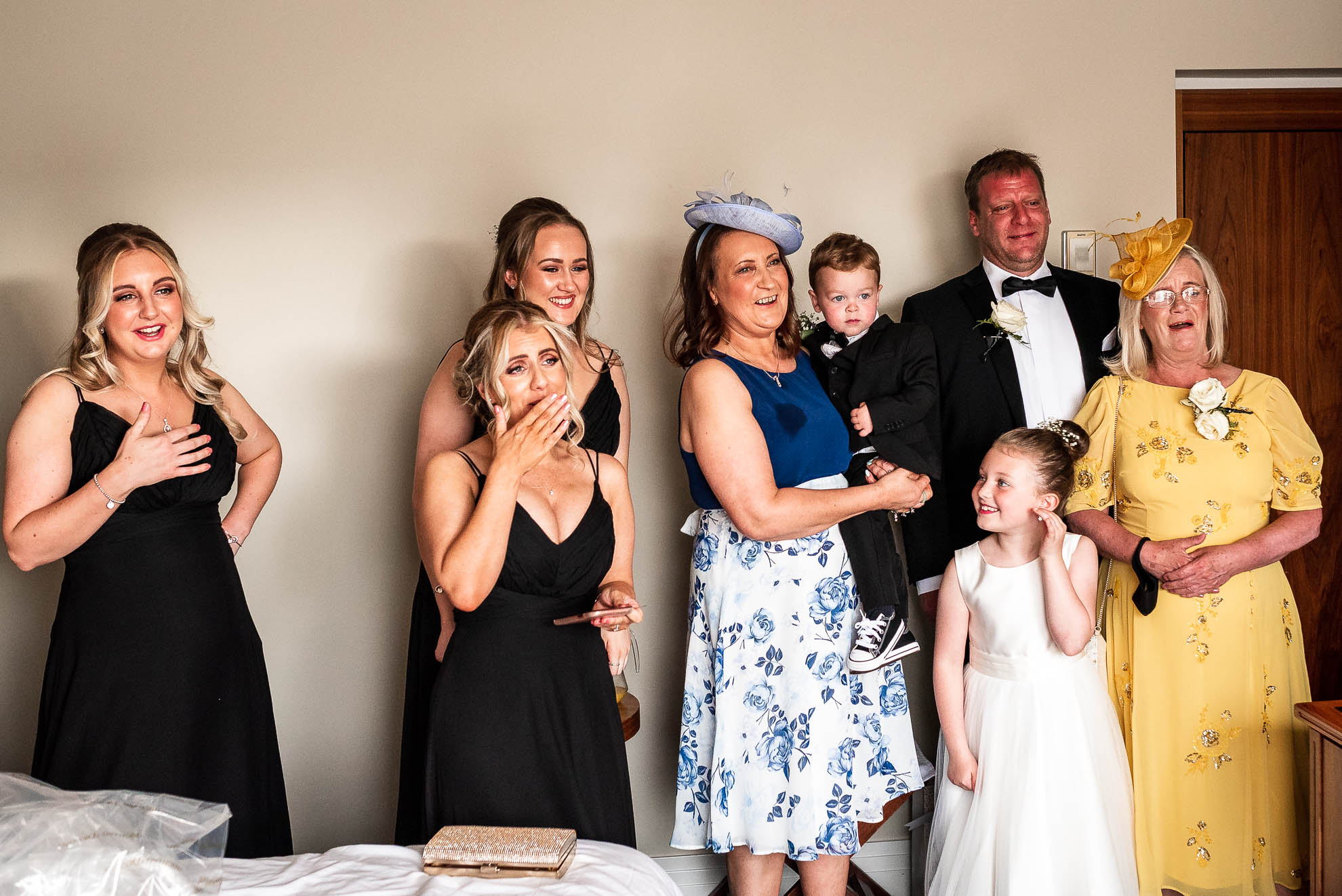 The bridal party see the brides dress for the first time