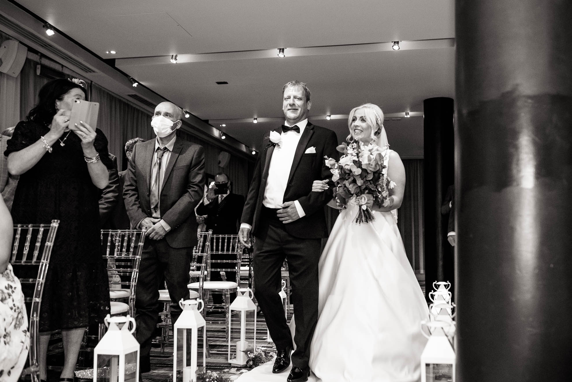Bride smiles at the groom as she walks up the aisle