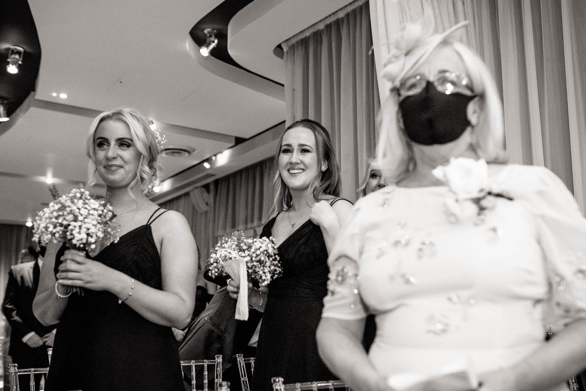Bridesmaids watch the bride walk up the aisle