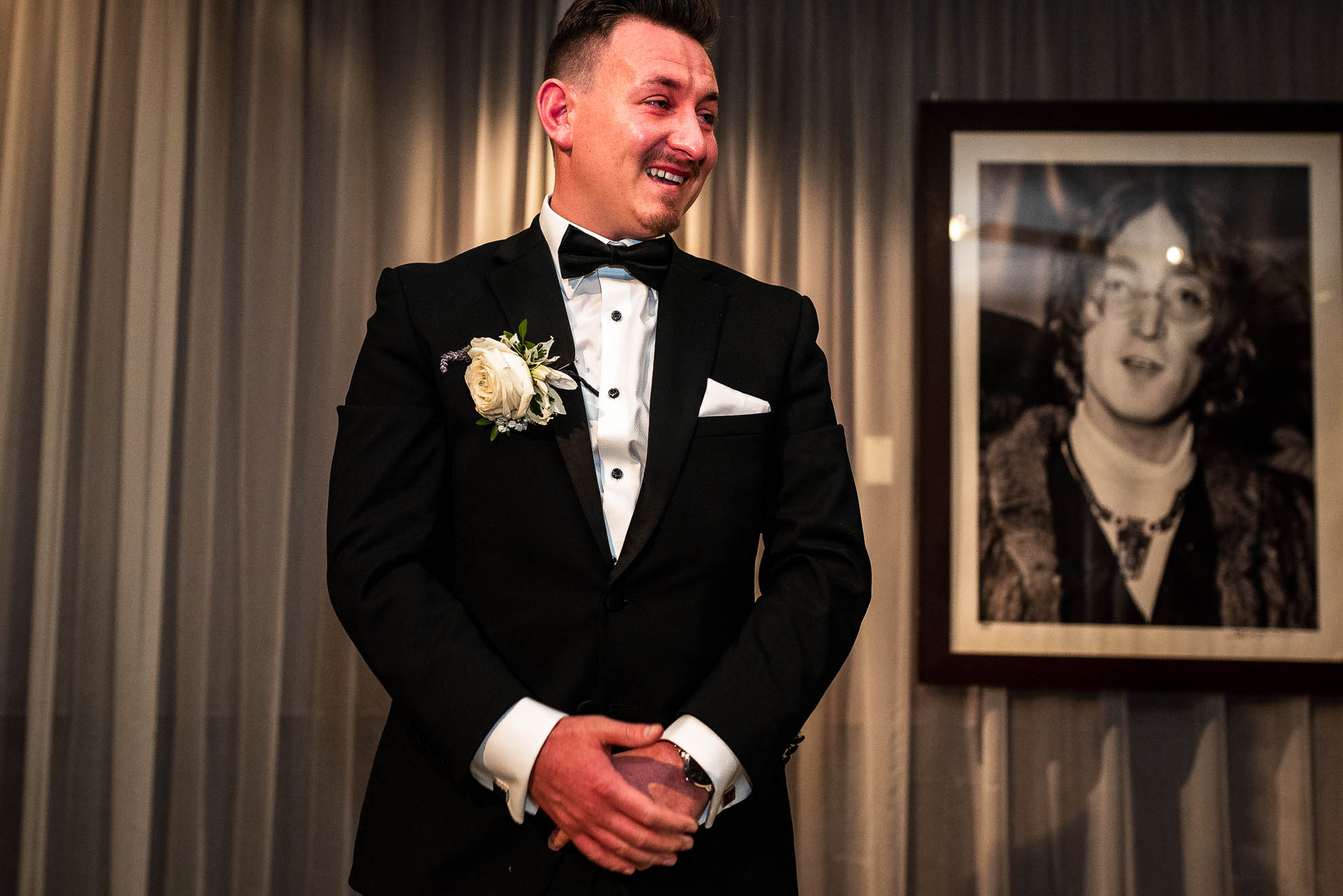Groom smiles as his bride walks up the aisle