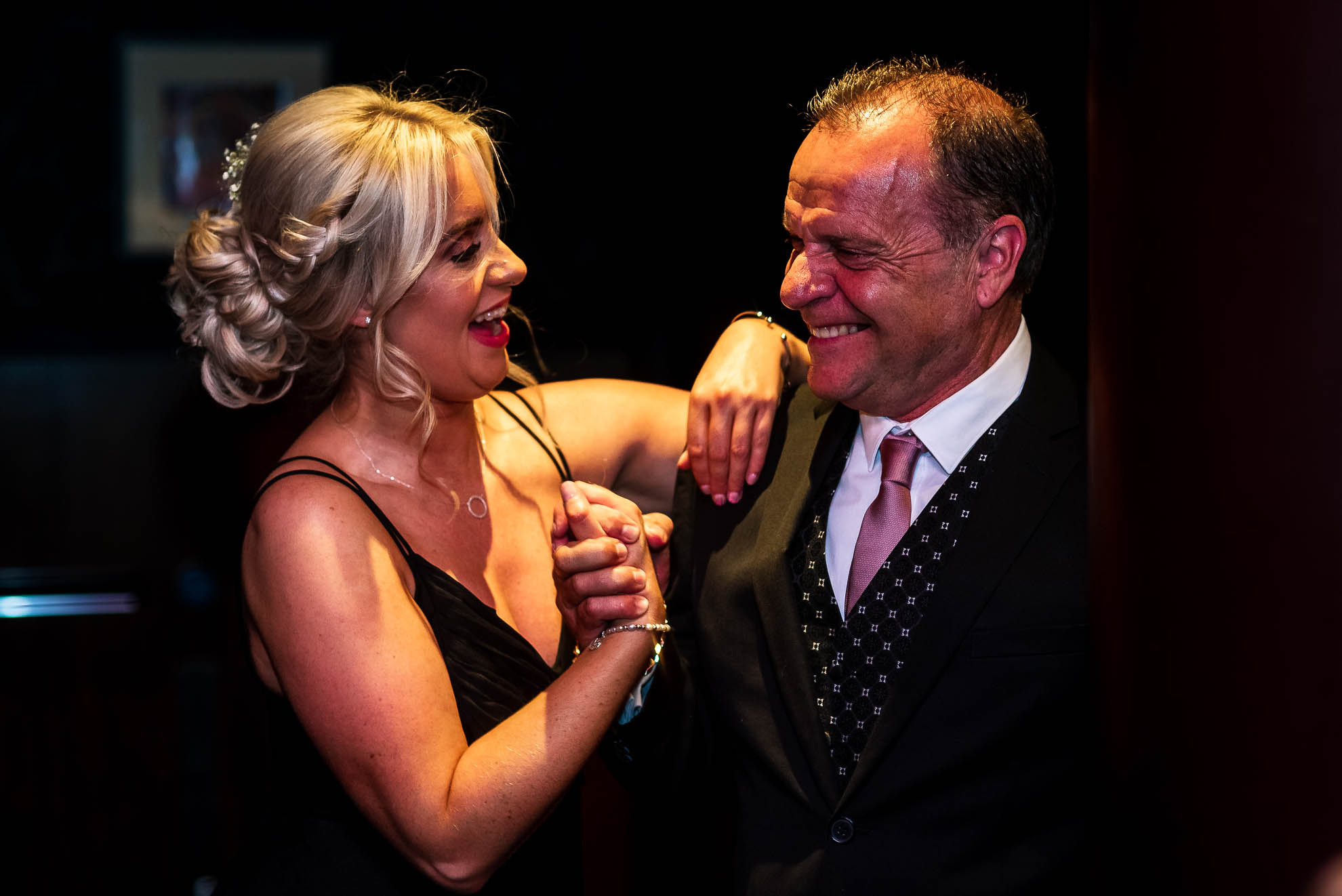 Bridesmaid shares a joke with wedding guest