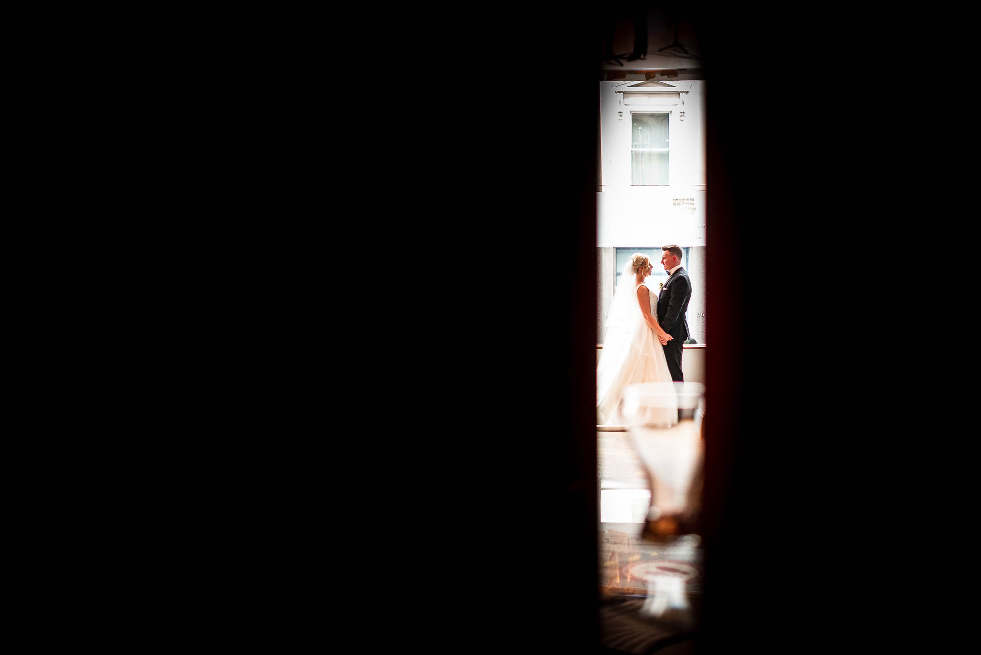 Bride and groom hold each other in the distance