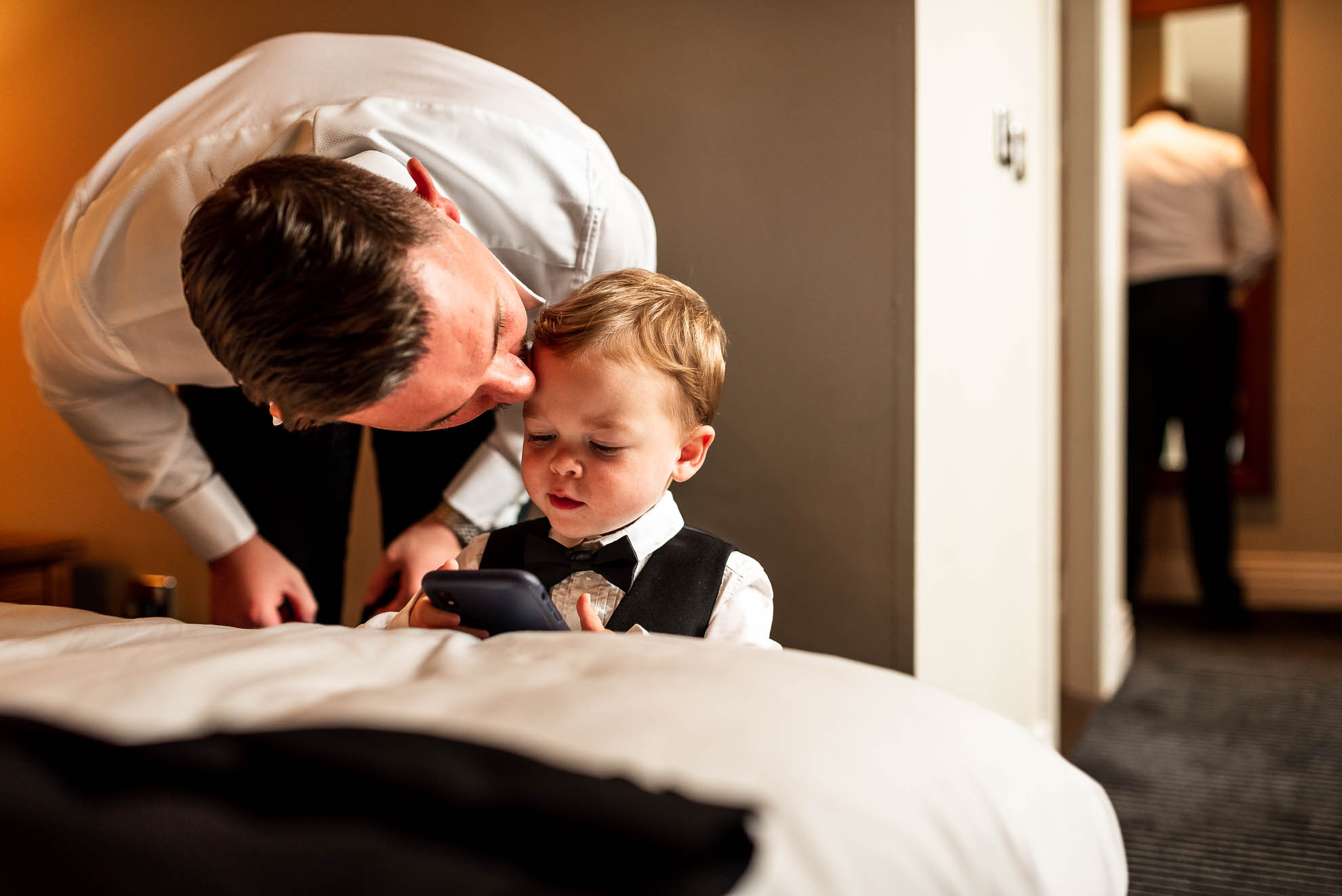 Groom kisses his son