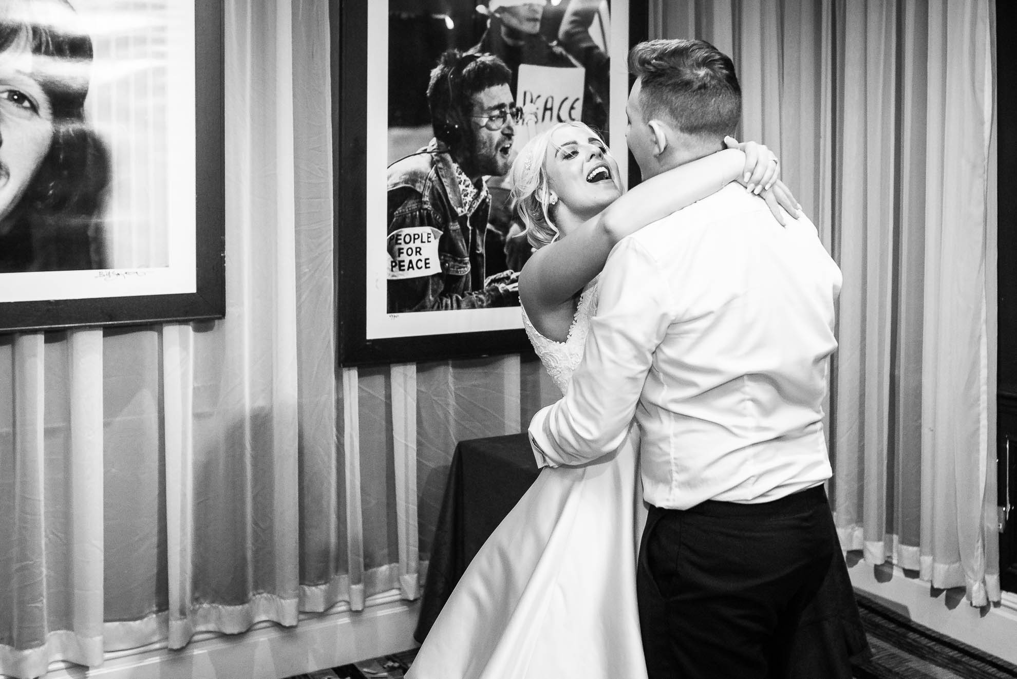 Bride and groom hold each other during first dance