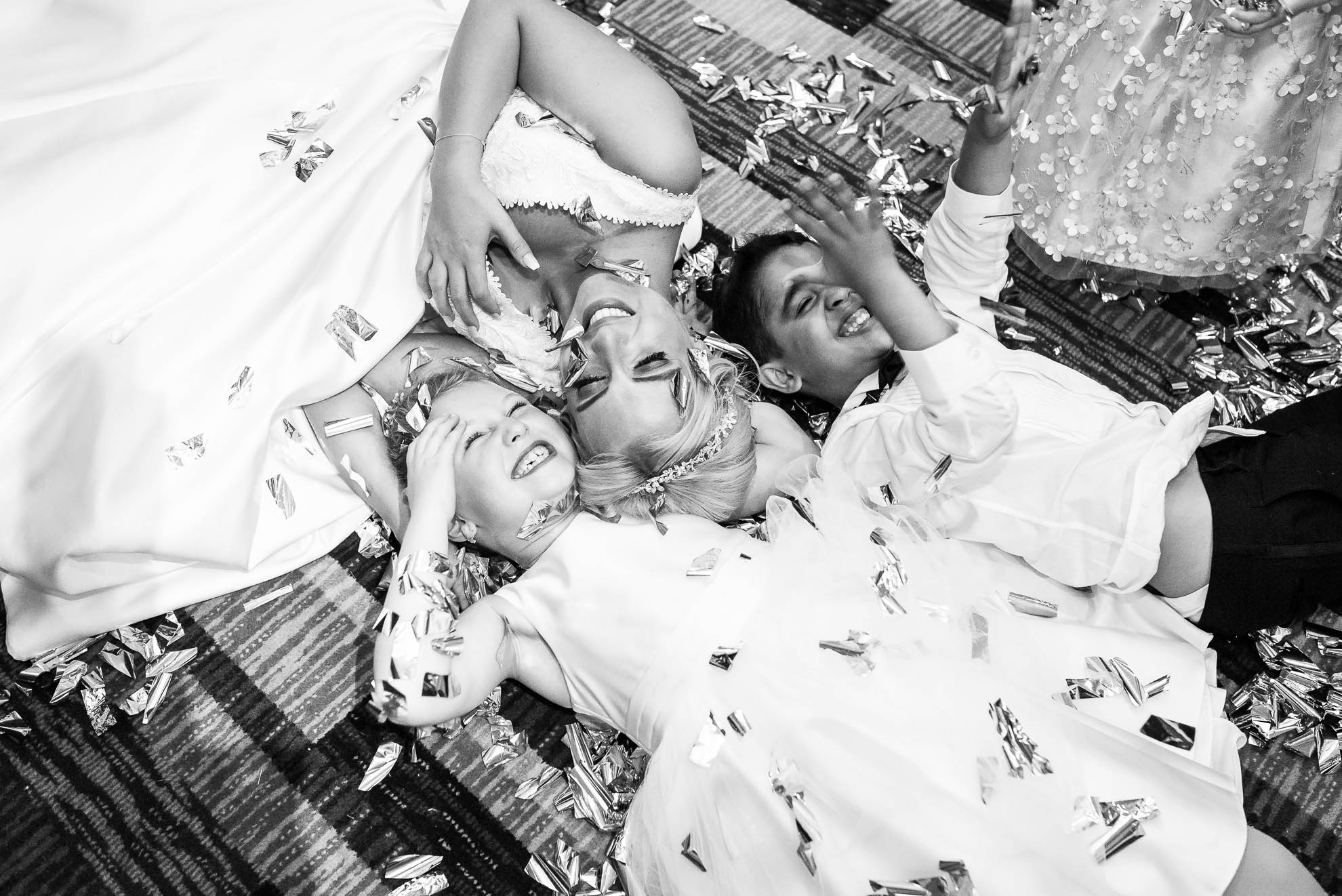 Bride and flower girl lying on floor