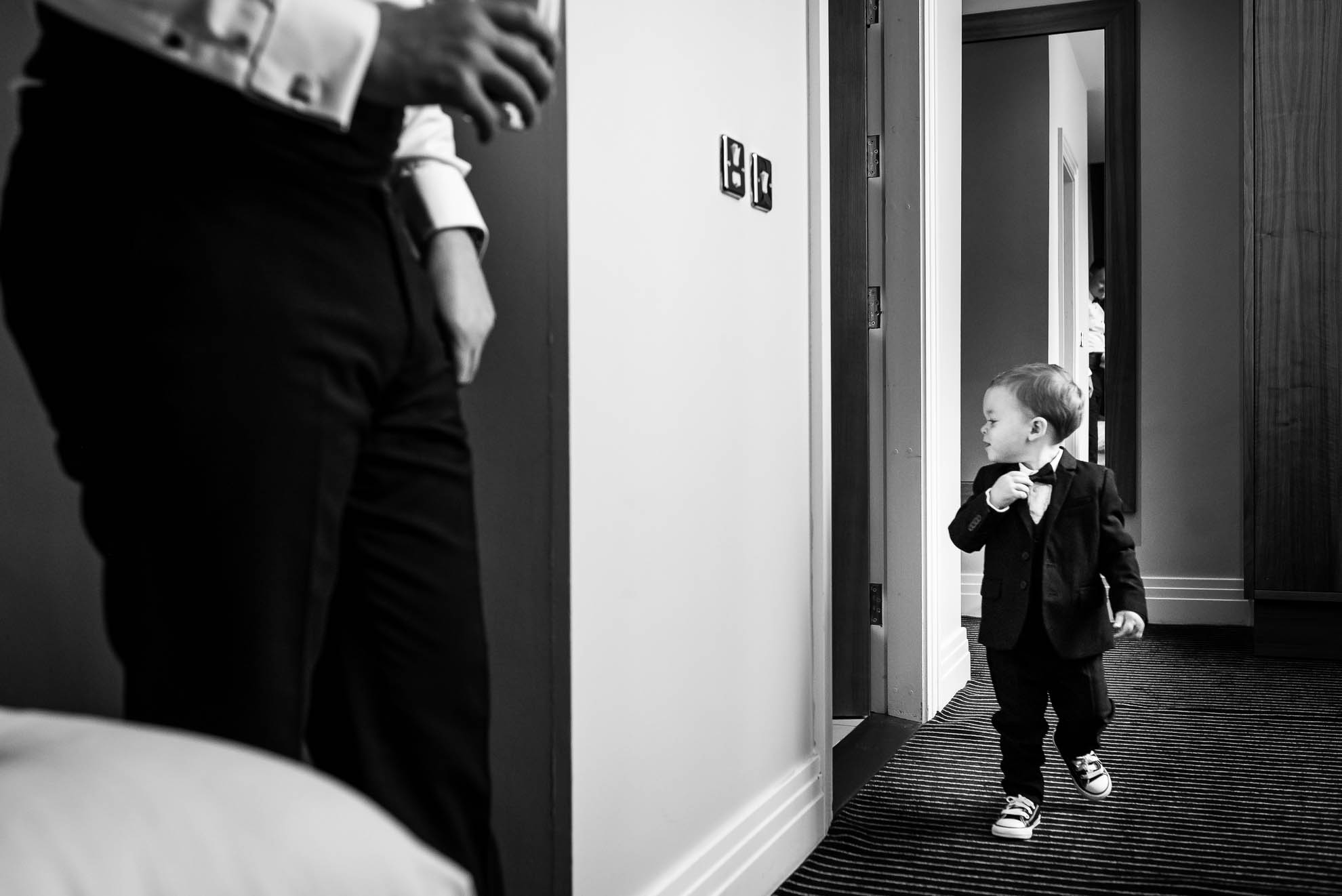 Grooms son looking in mirror