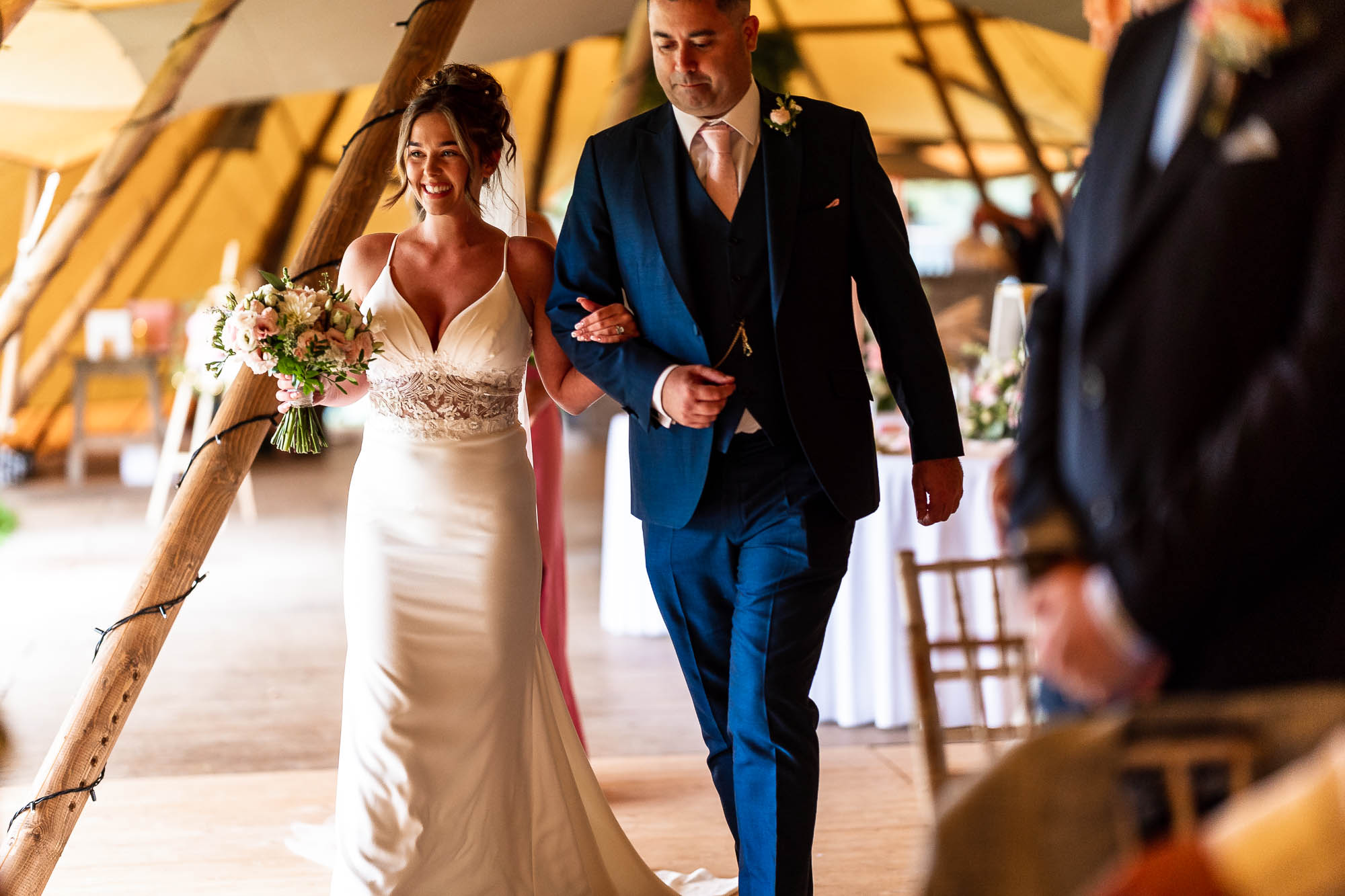 Bride walks up the aisle with the father of the bride