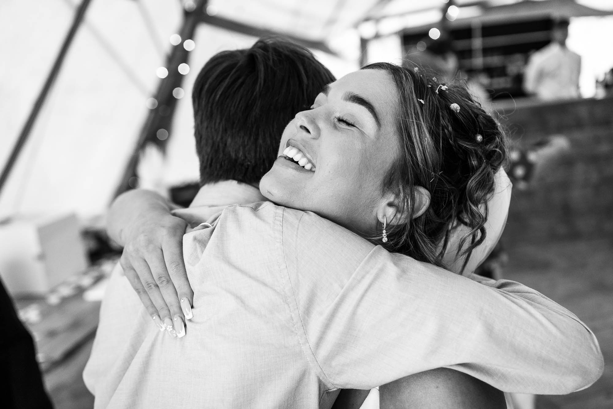 Guest hugs bride