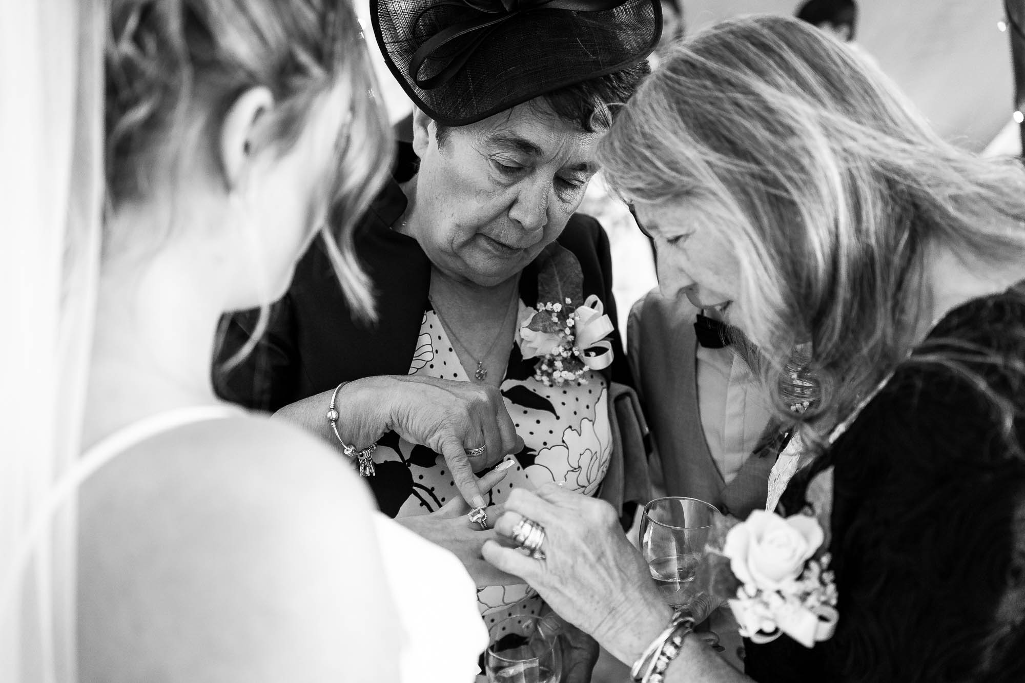 Wedding guests admire brides wedding ring