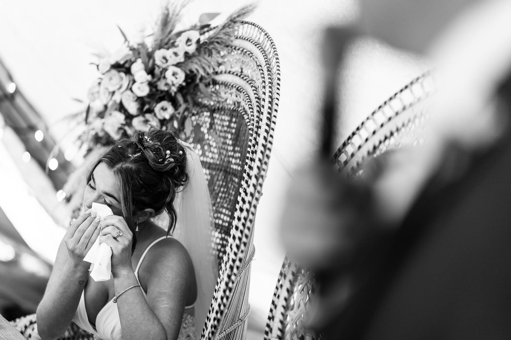 Bride wipes away tear during speeches at Betty's Tipi Inglenook farm
