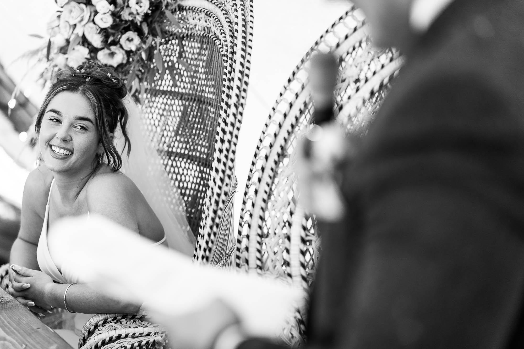 Bride laughs during grooms speech