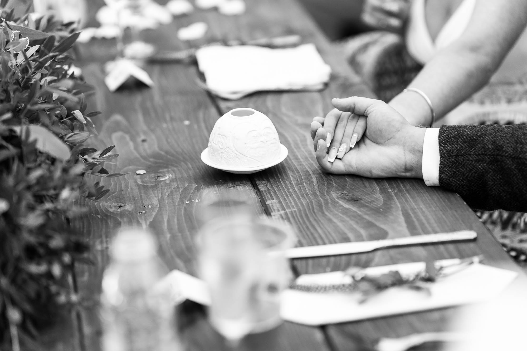 Bride and groom hold hands