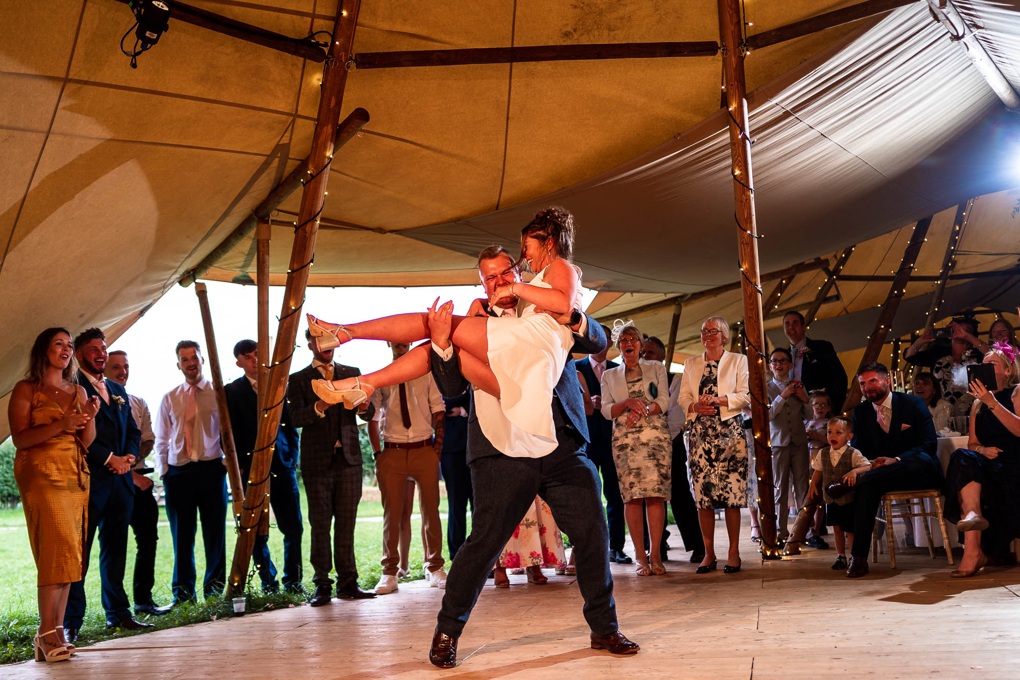 Groom picks up bride