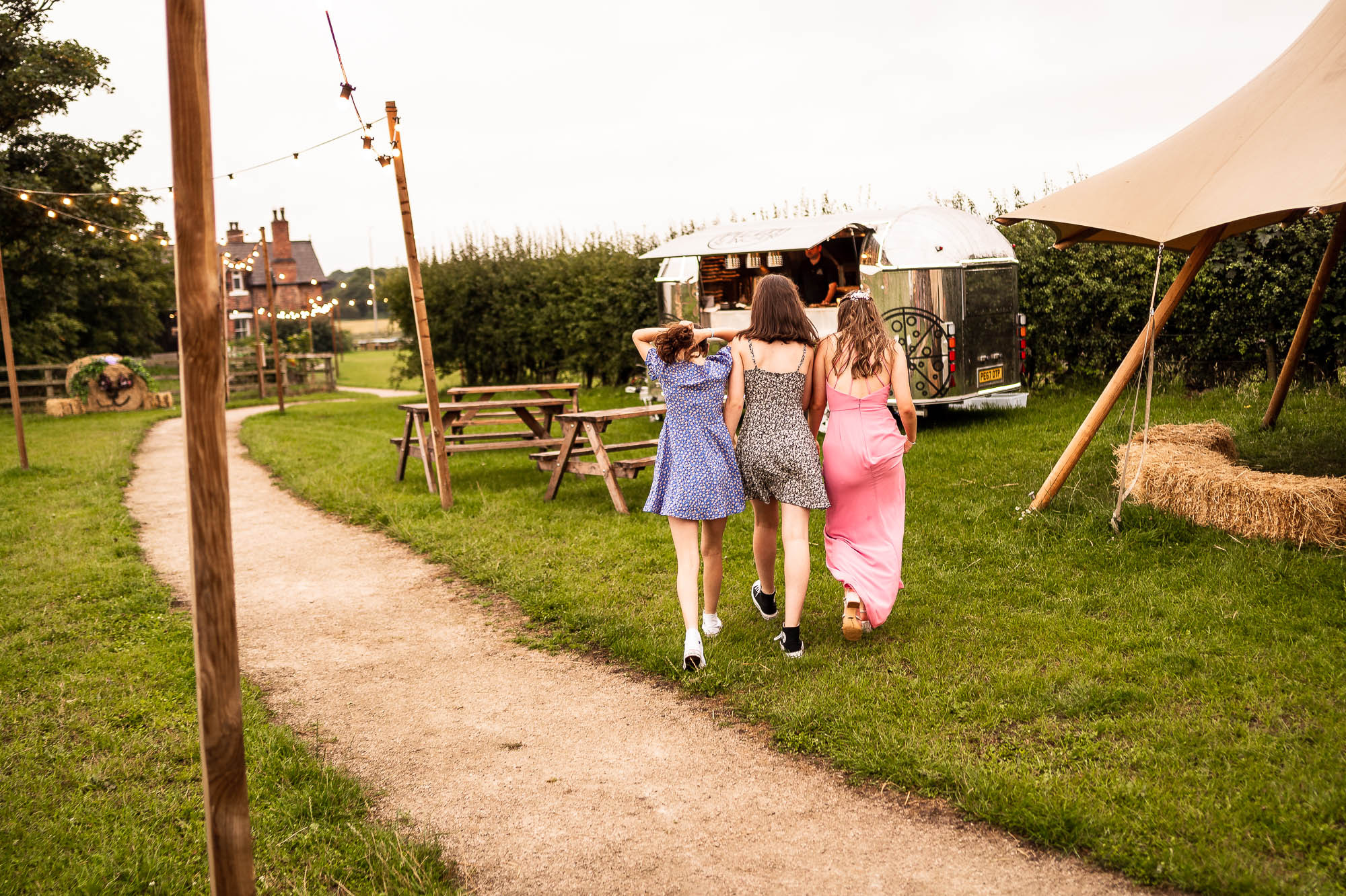 Wedding guests walk to pizza van
