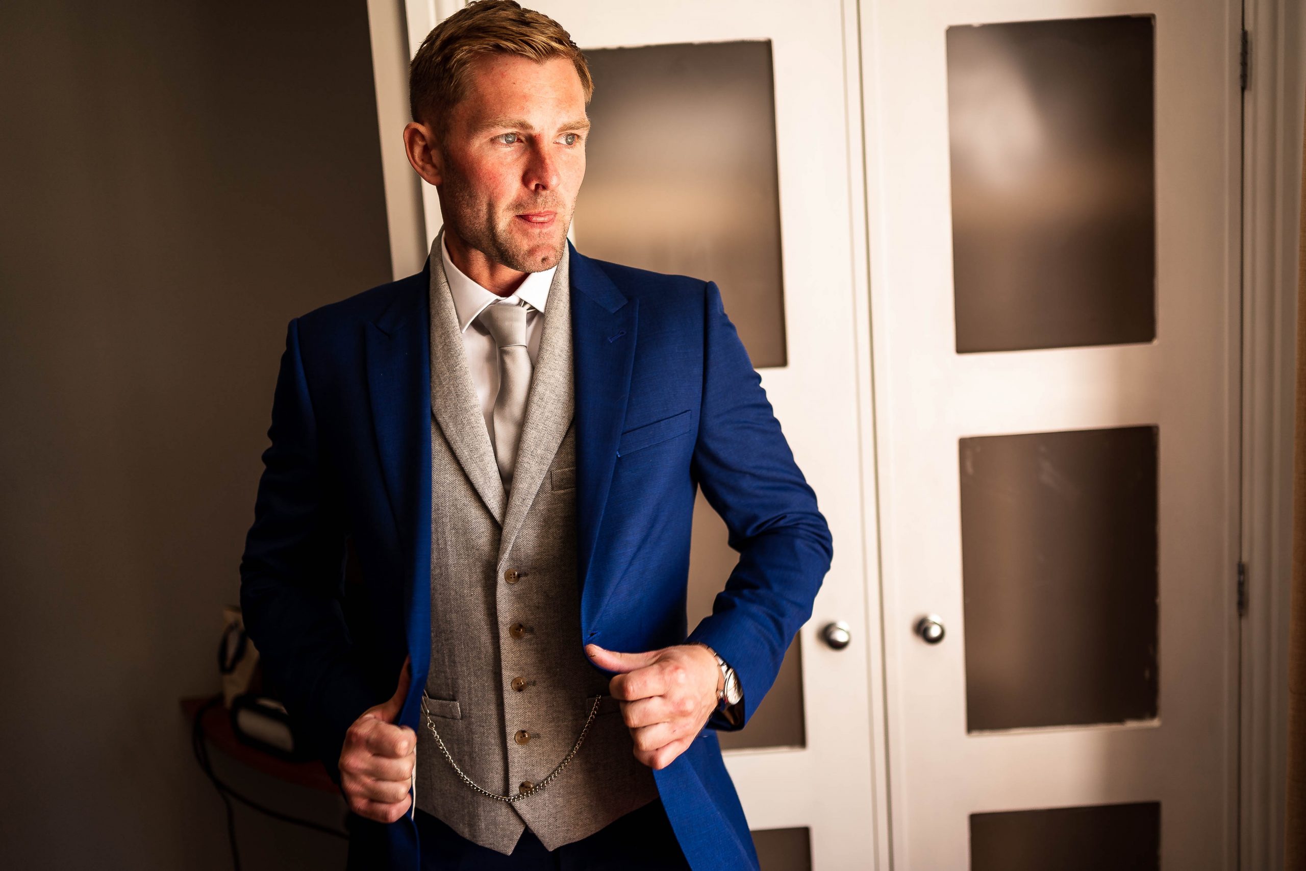 Groom puts on his jacket
