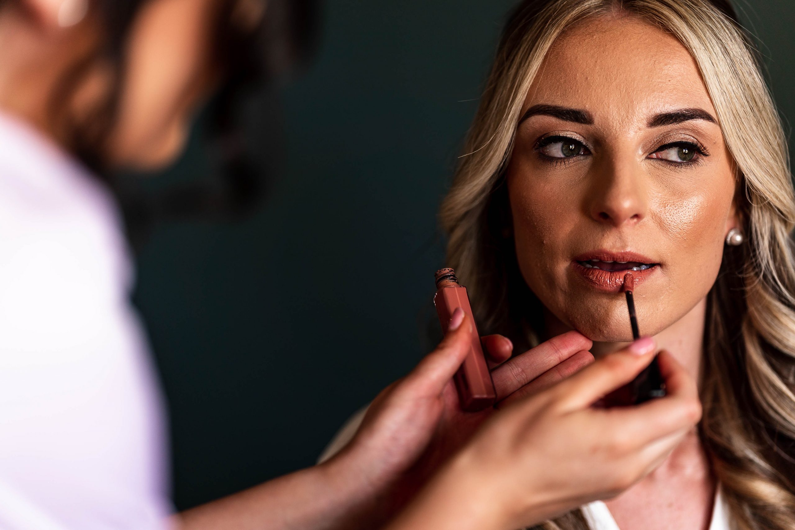 Brdie having her make up applied