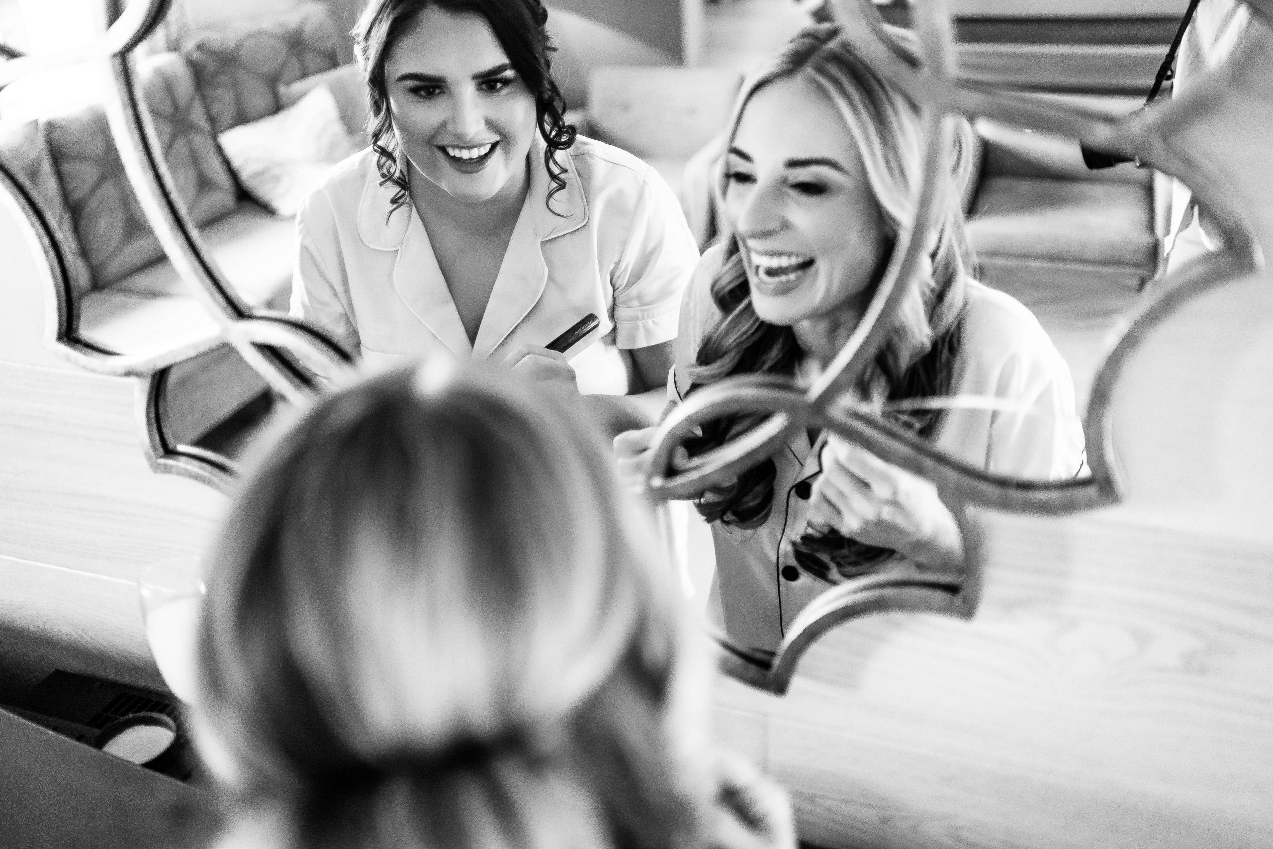 Bride and bridesmaid share a joke