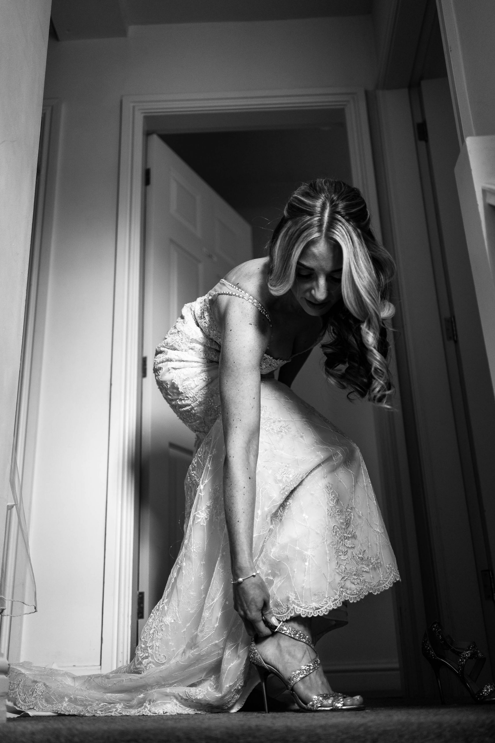 Bride adjusts her shoes
