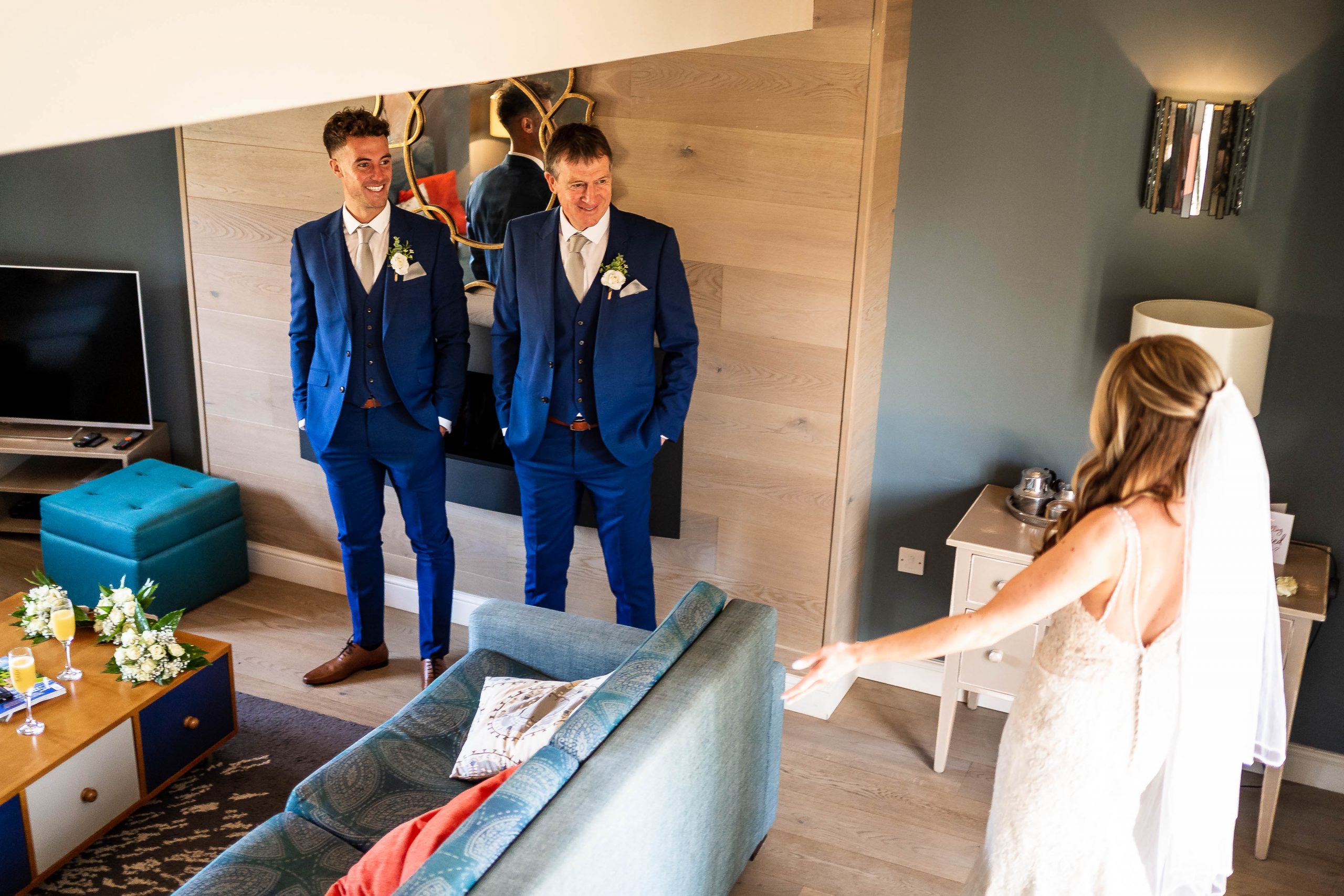 Father of the bride sees bride in her dress for the first time