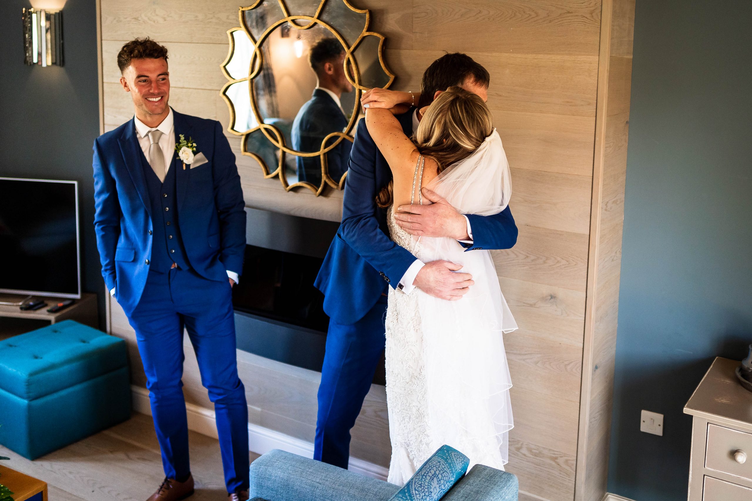 Father of the bride hugs the bride