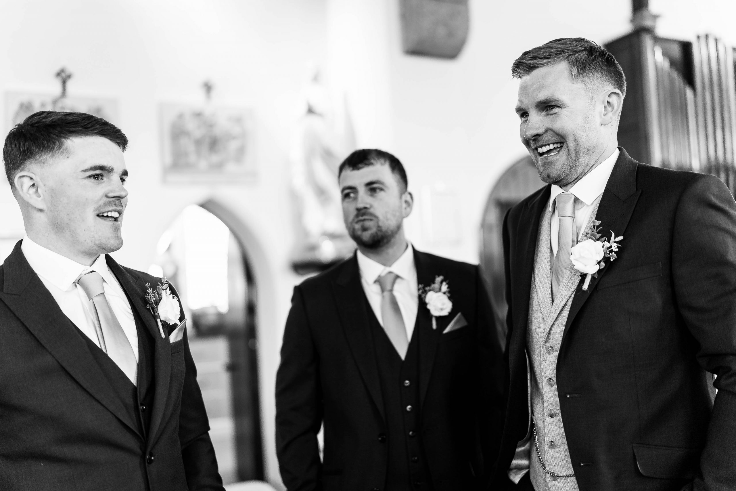 Groom shares a joke with his groomsmen