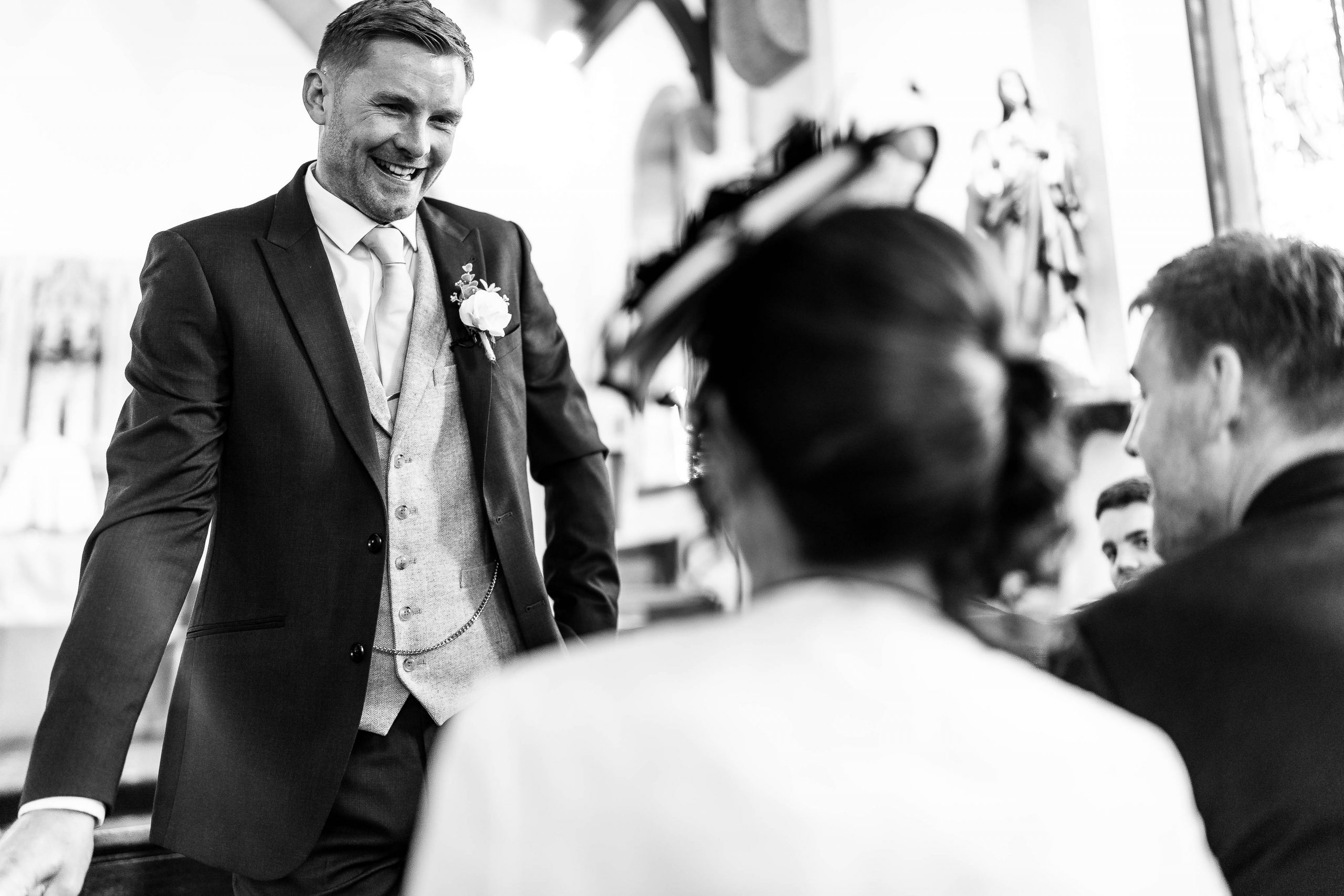 Groom shares a joke with the mother and father of the groom