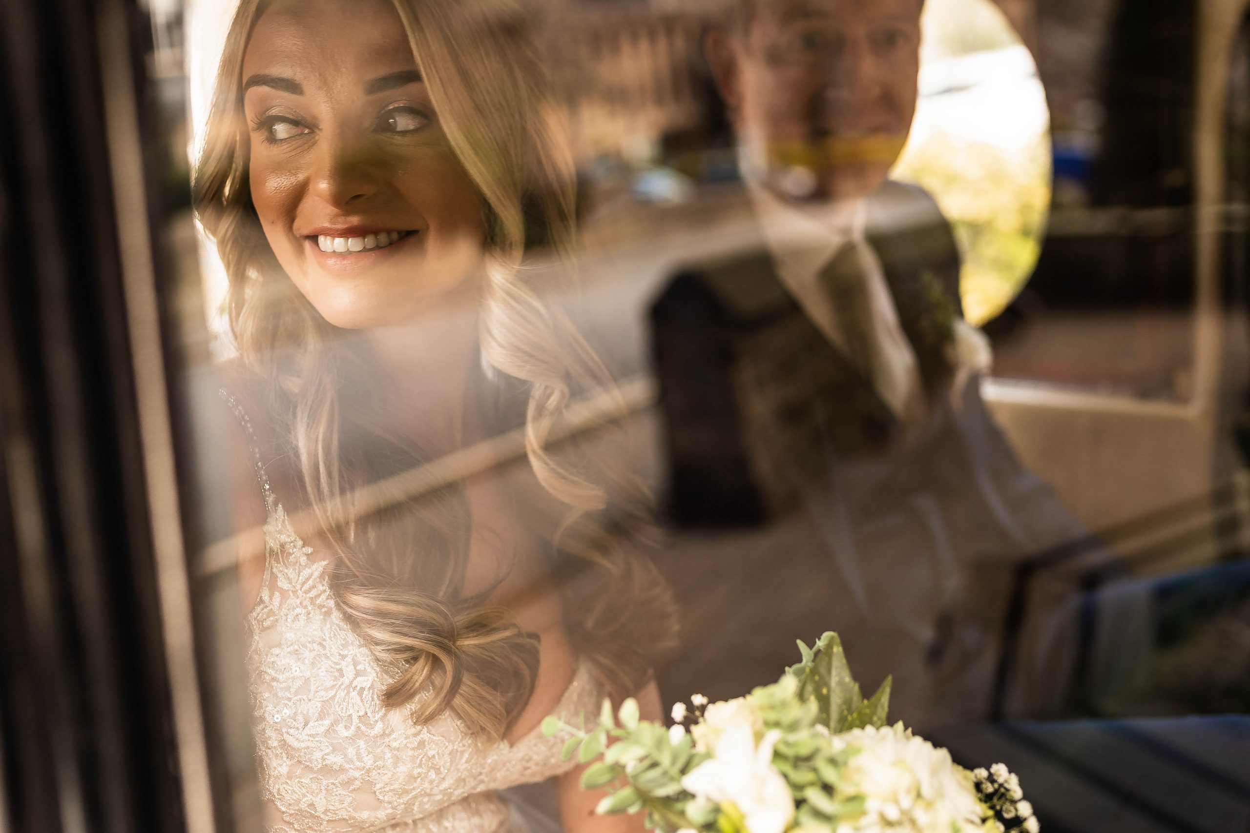 Bride arrives at church with father of the groom