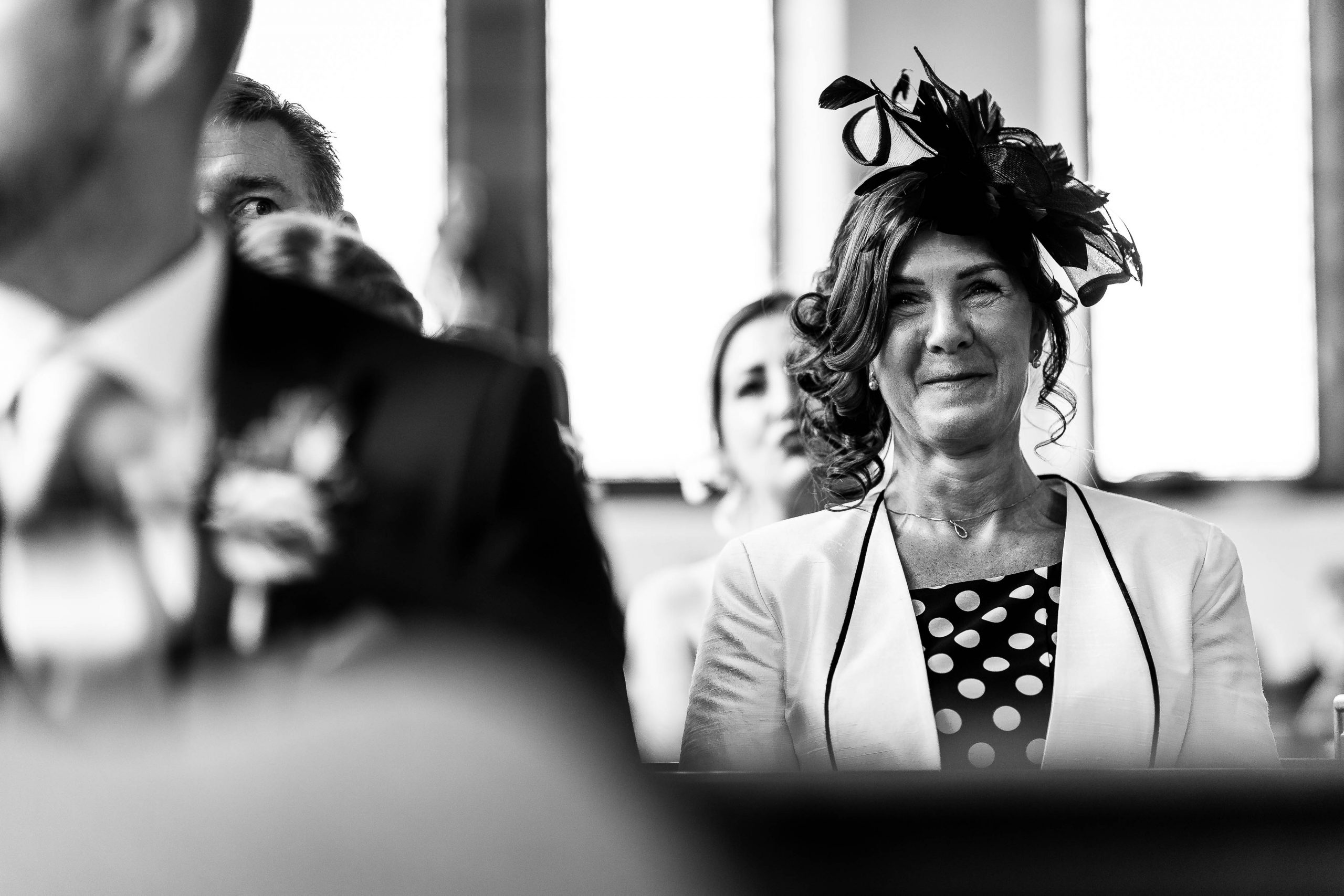 Mother of thr groom smiles during the ceremony