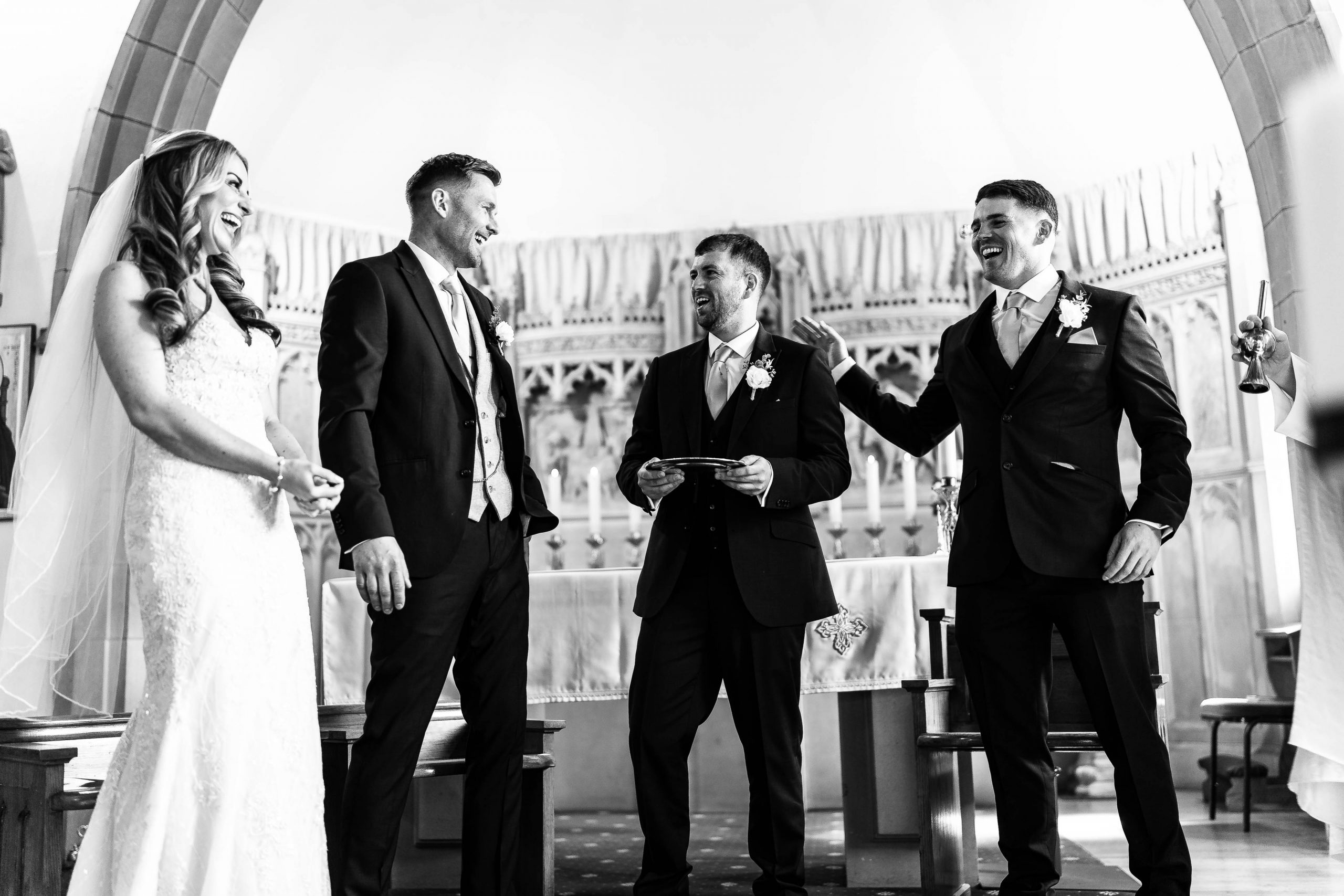 Bride and groom share a joke with the groomsmen
