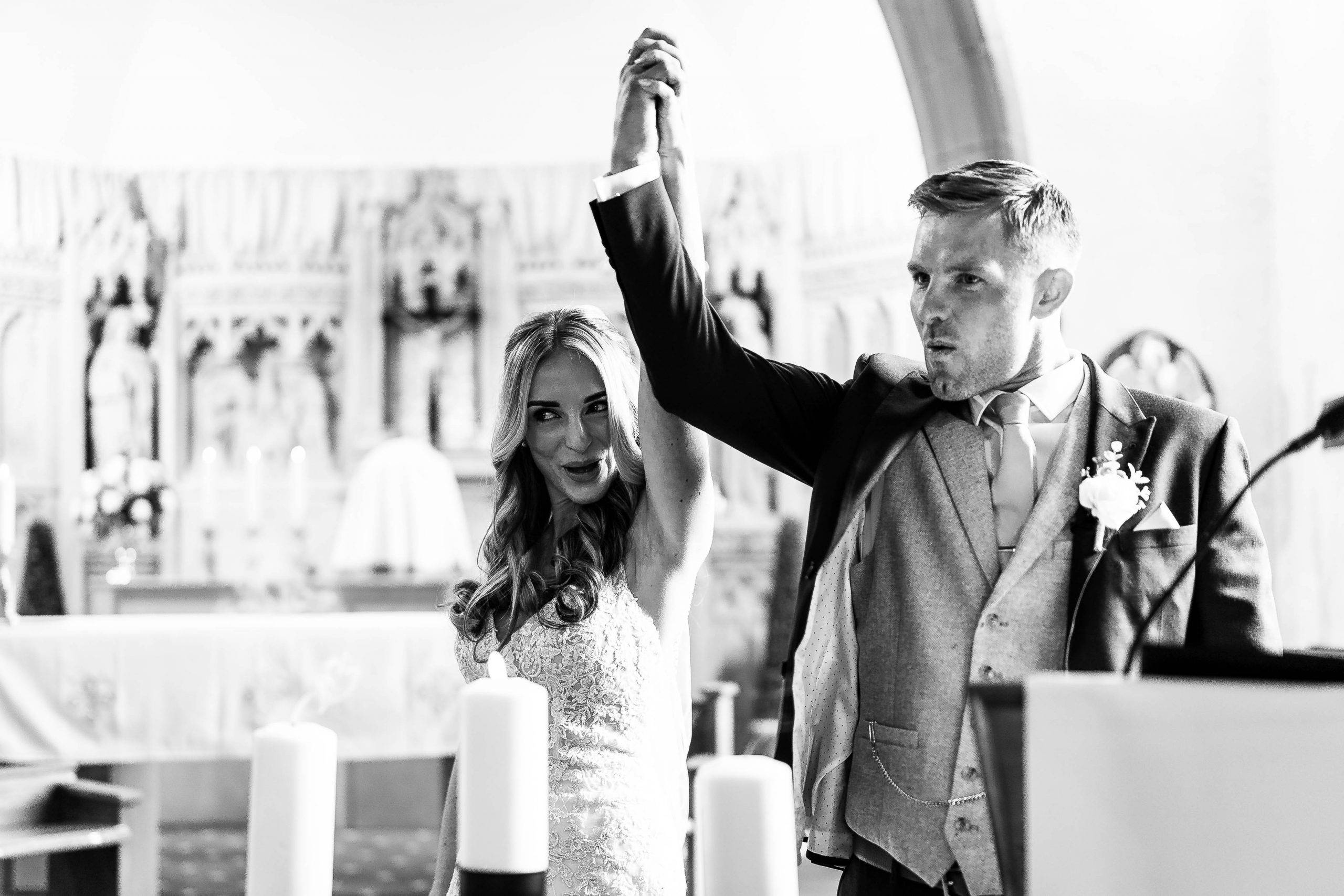 Bride and groom hold hands 
