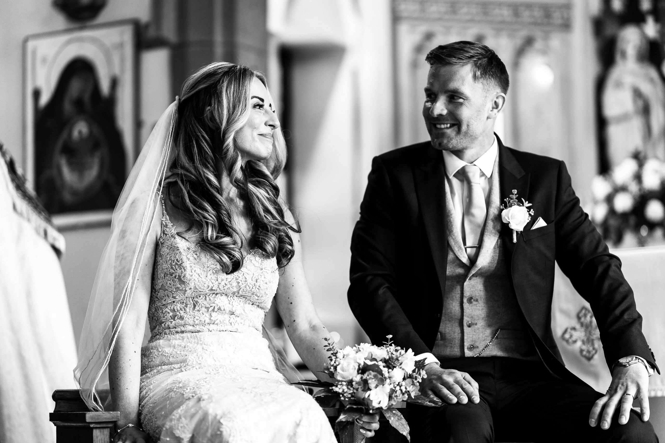 Bride and groom look at each other and smile