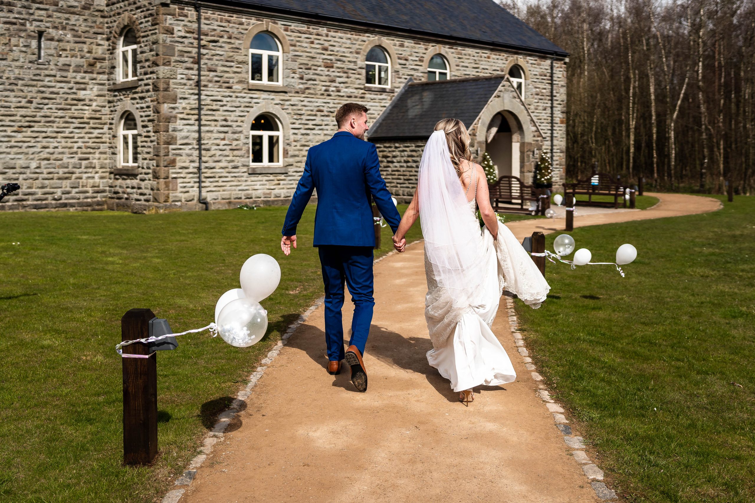 Bride and groom walk to Darwin hall
