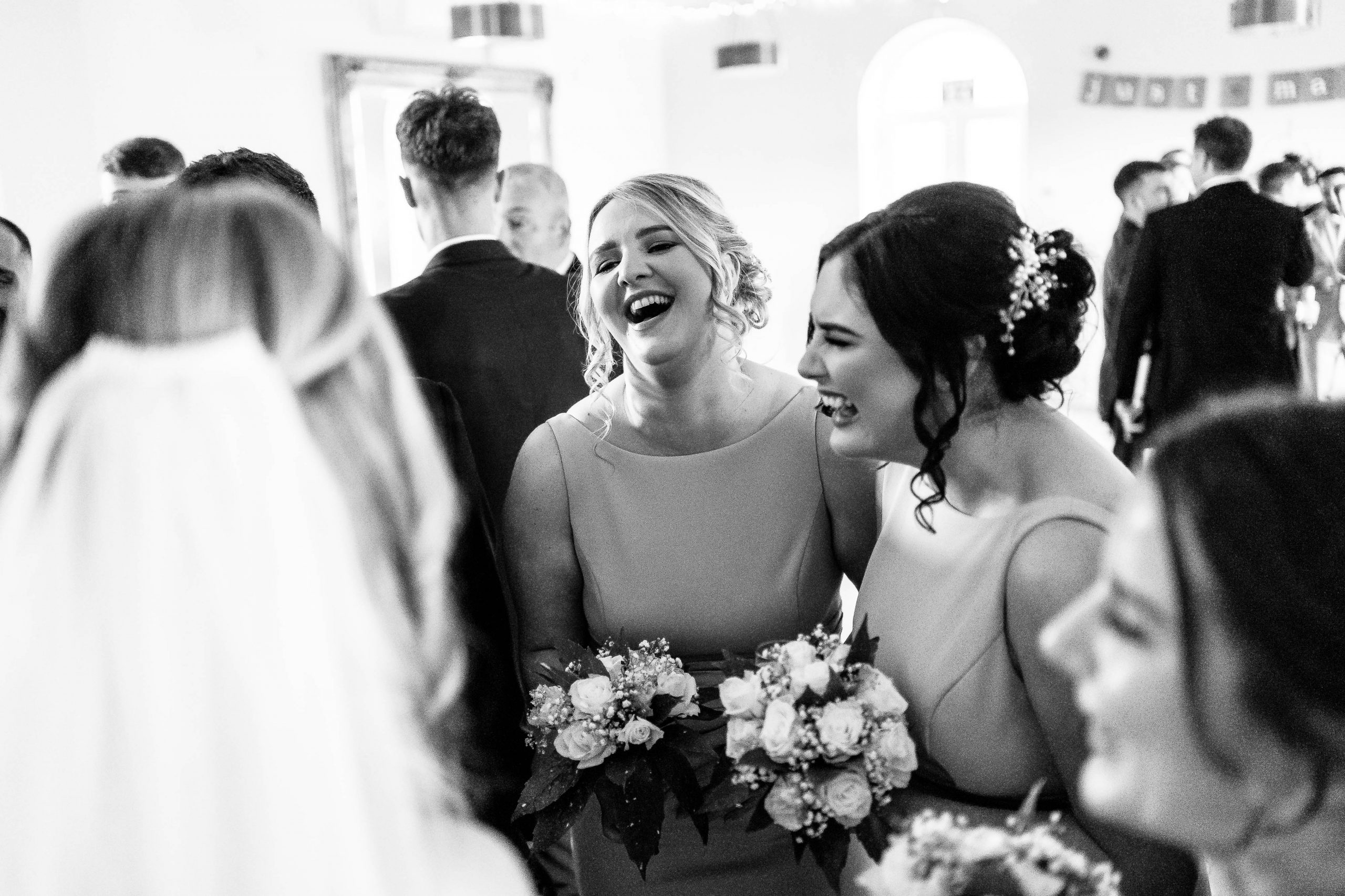 Bridesmaids share a joke with the bride