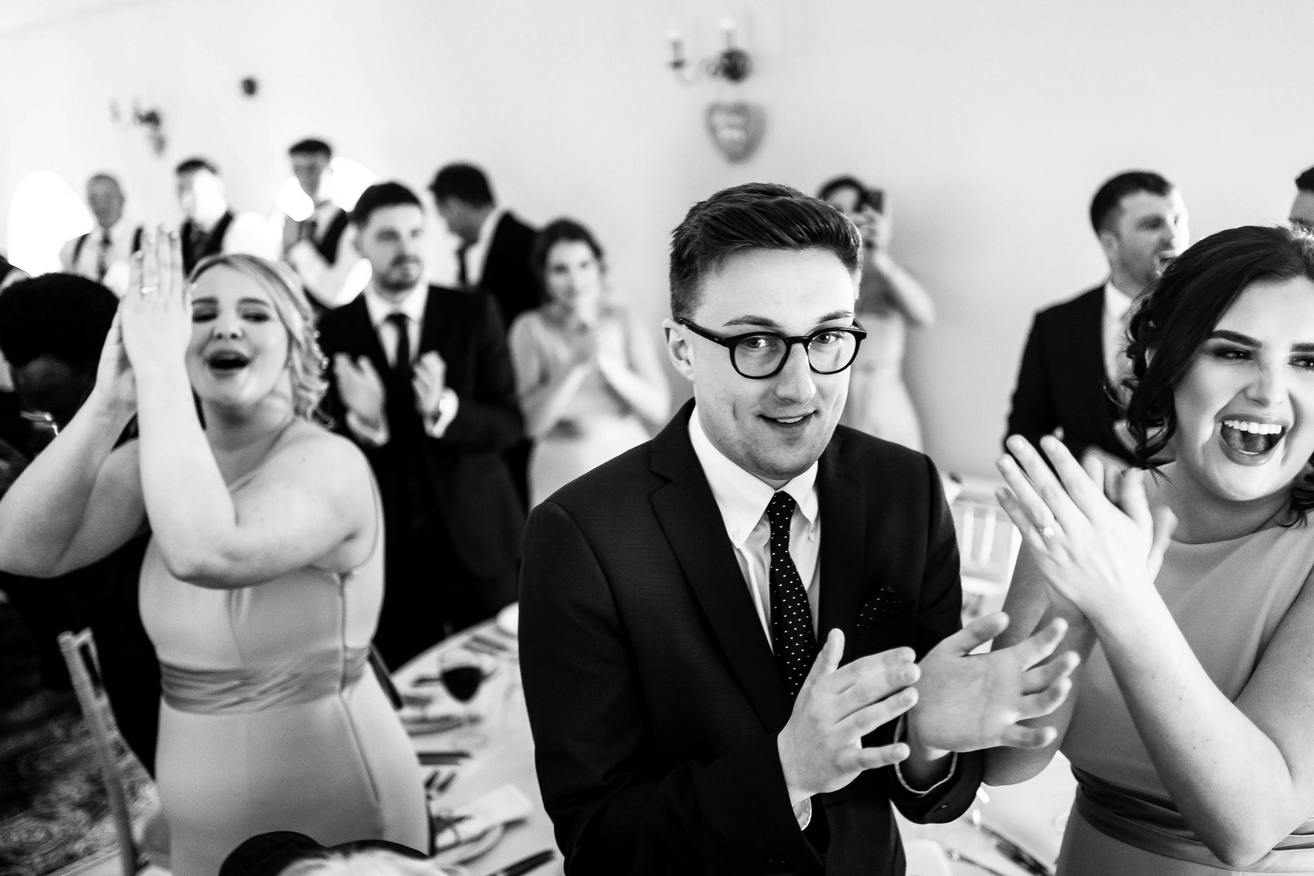 Bridesmaids welcome bride and groom into wedding breakfast