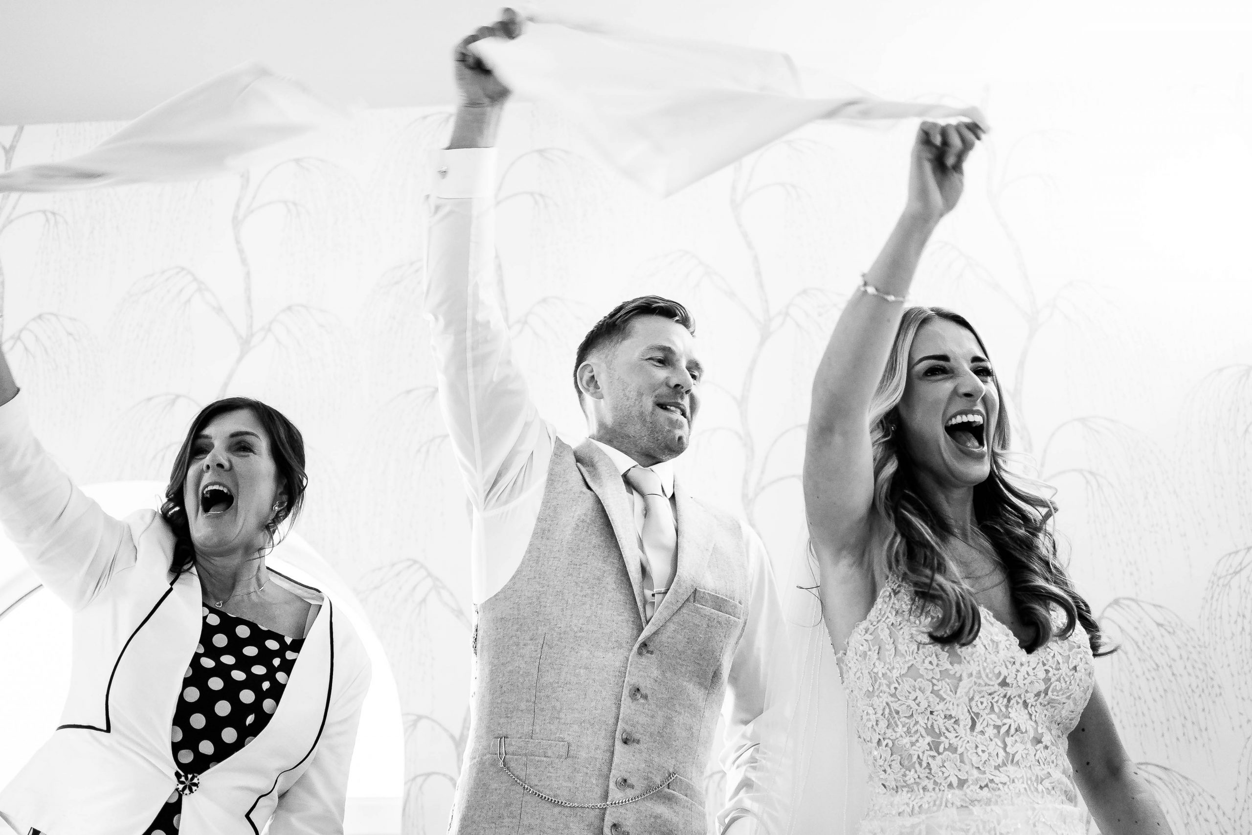 Bride and groom waving their napkins