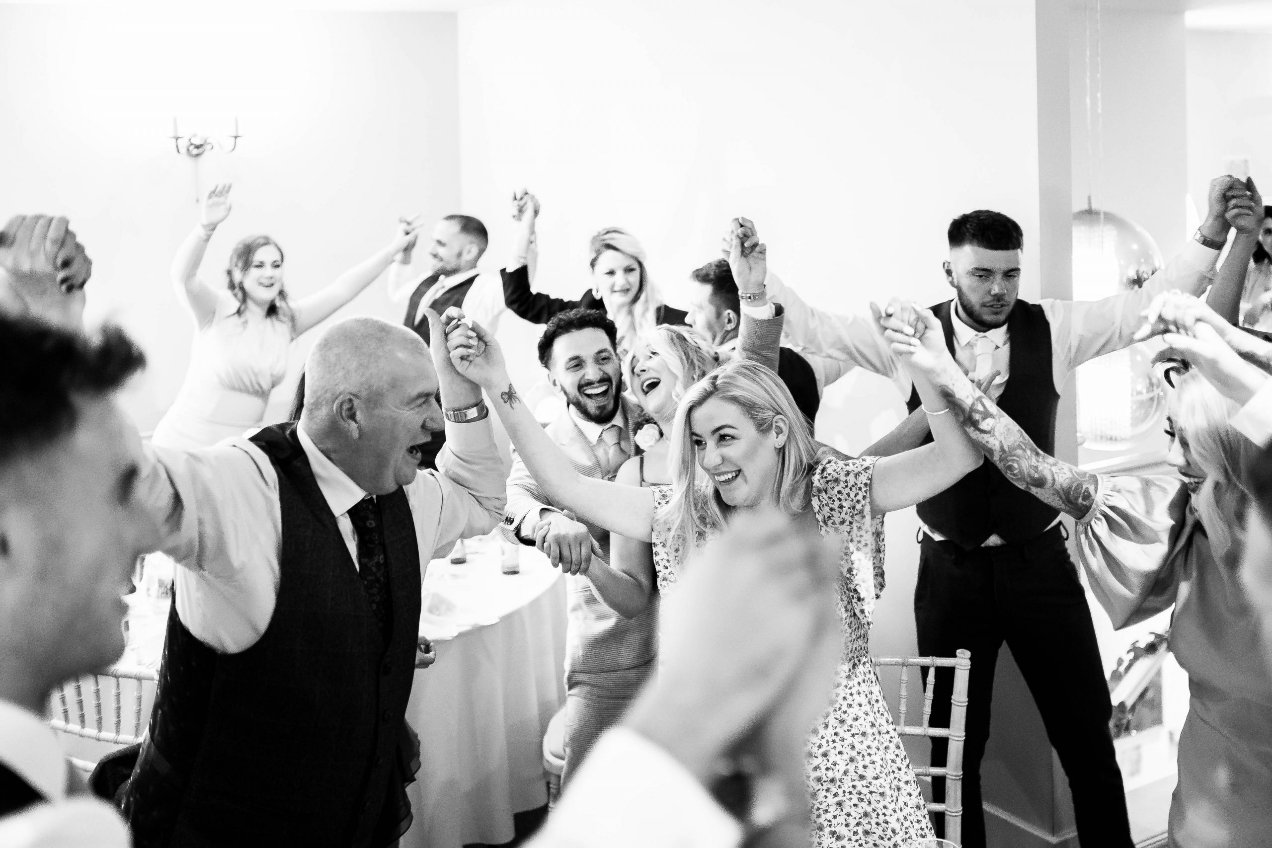 Wedding guests holding hands and singing