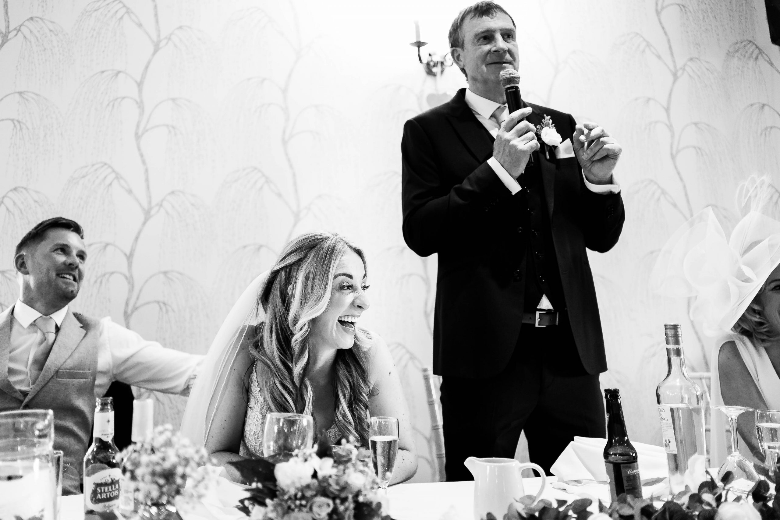 Bride laughs during father of the brides speech