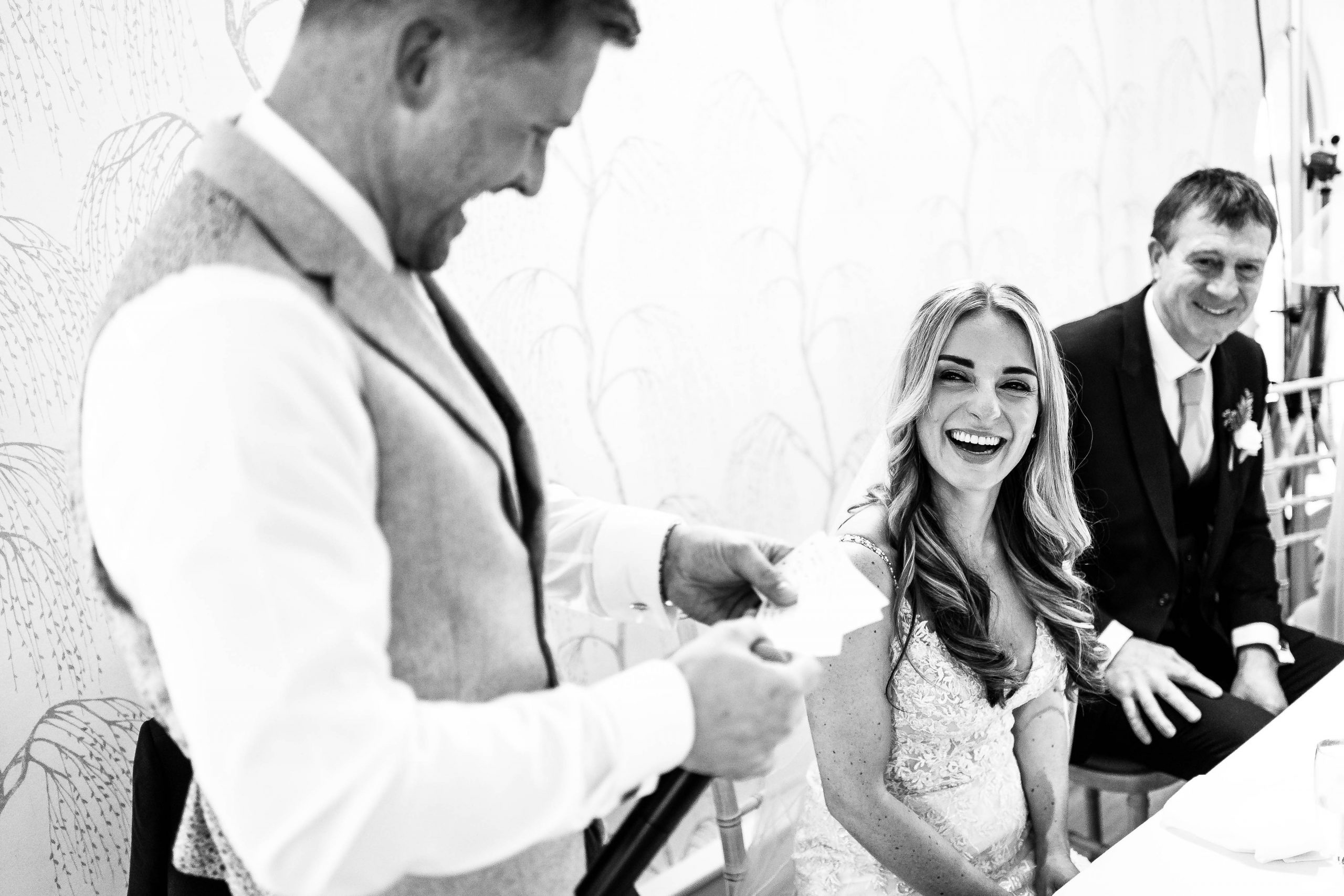 Bride laughs during groom's speech