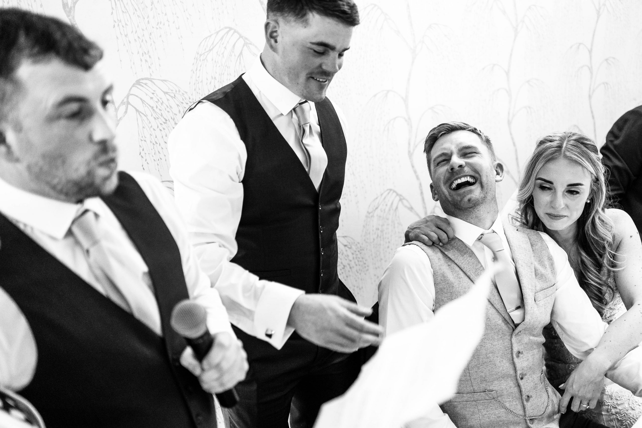 The groom laughs during best men's speeches