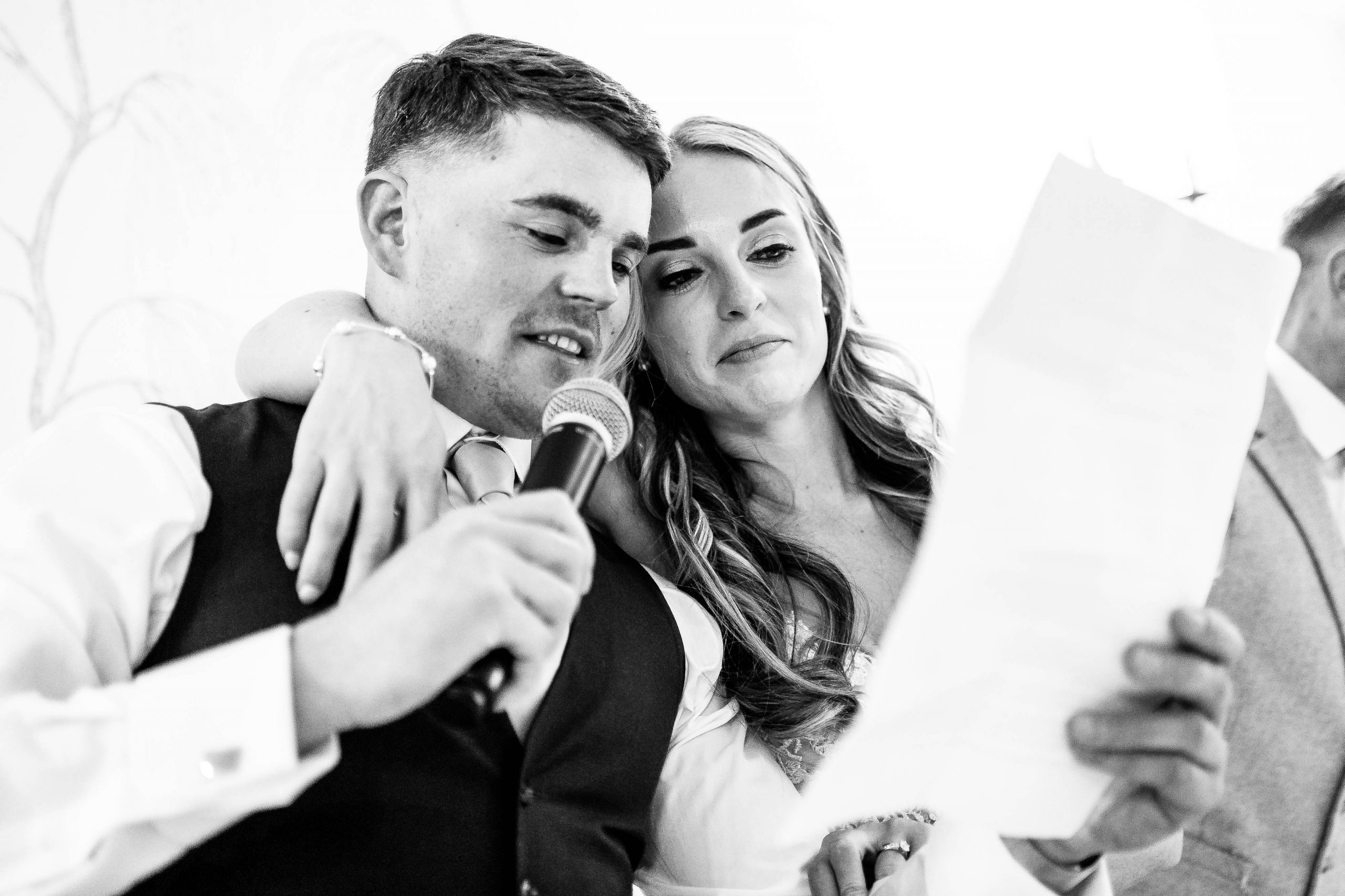 Bride hugs best man during his speech