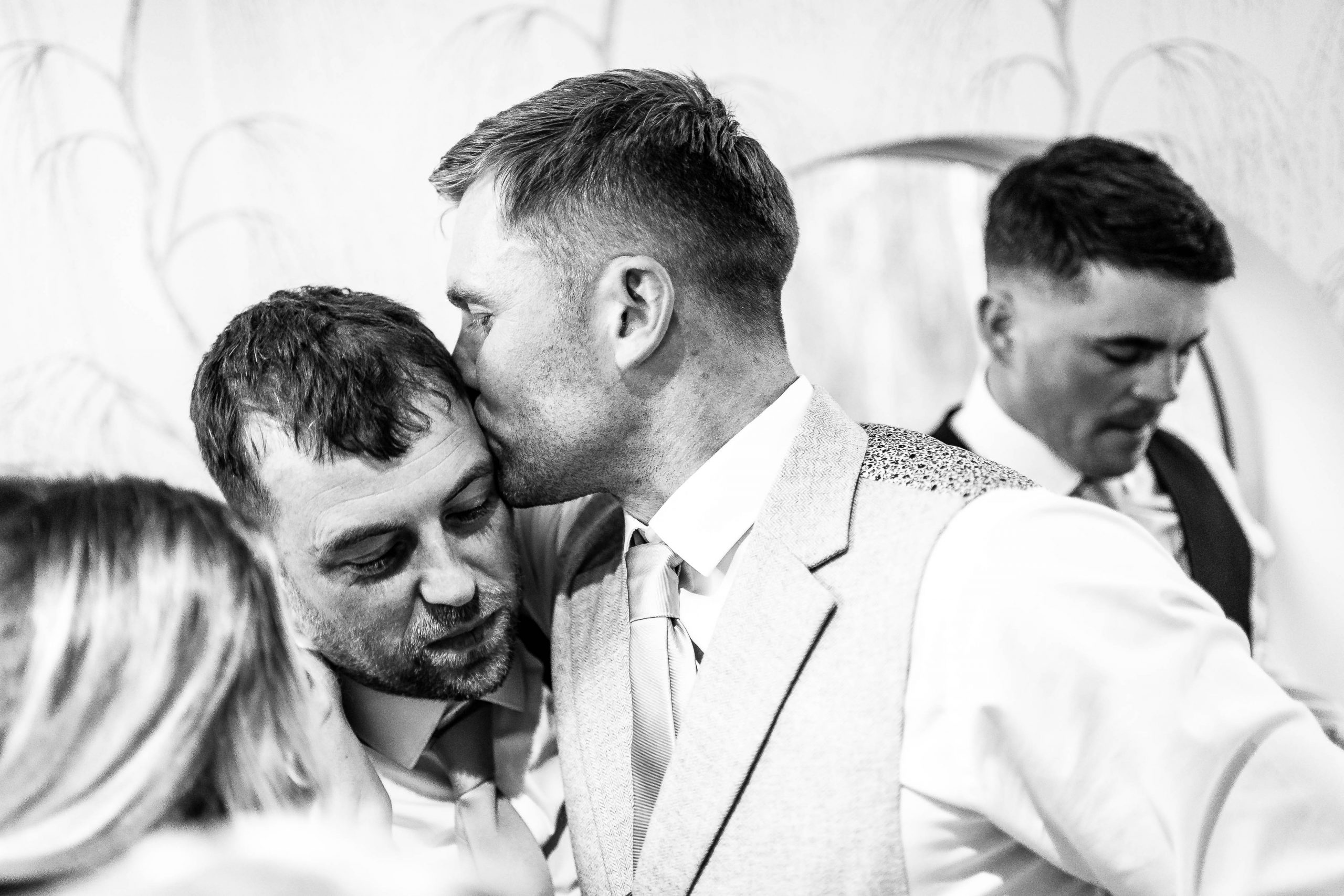 Groom kisses best man 