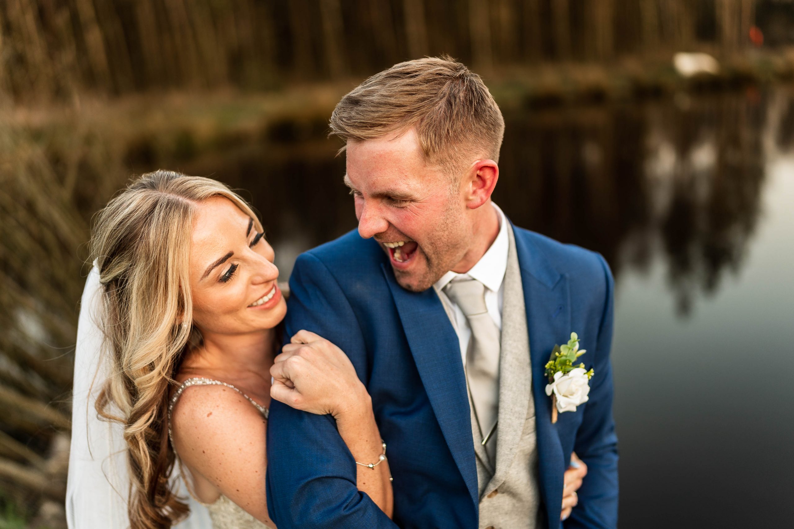 Groom luaghs during portraits