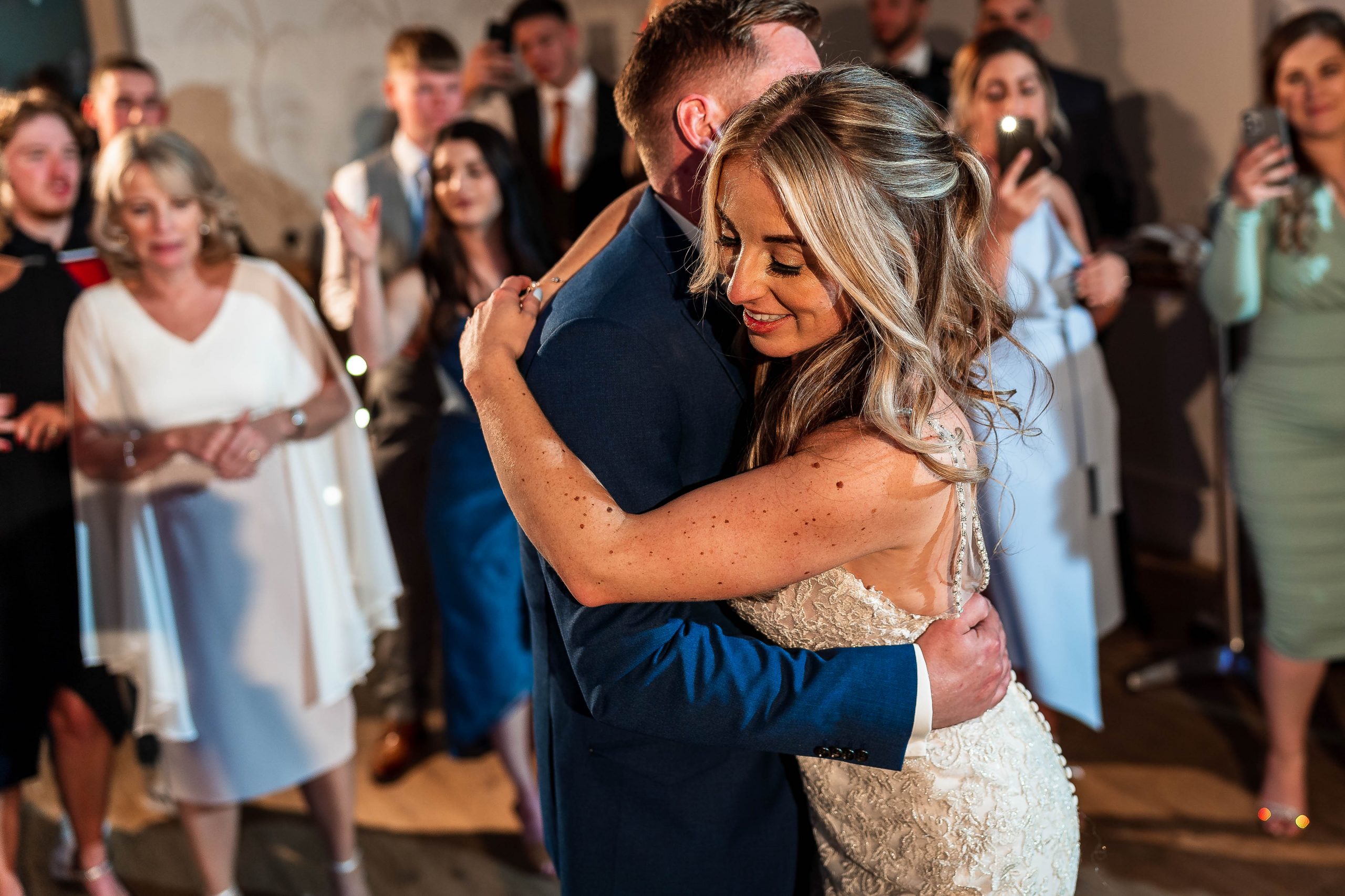 Bride hugs groom during first dance