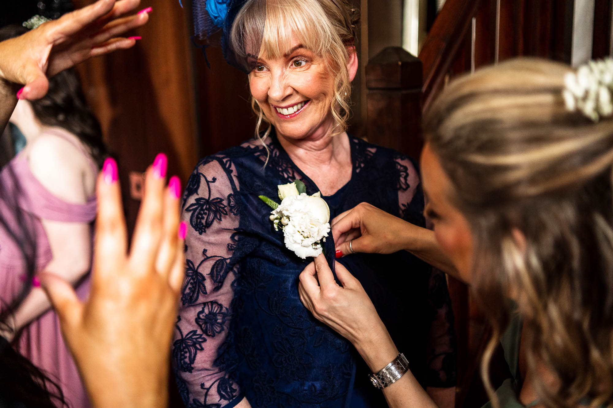 Mother of bride chats with bridesmaids