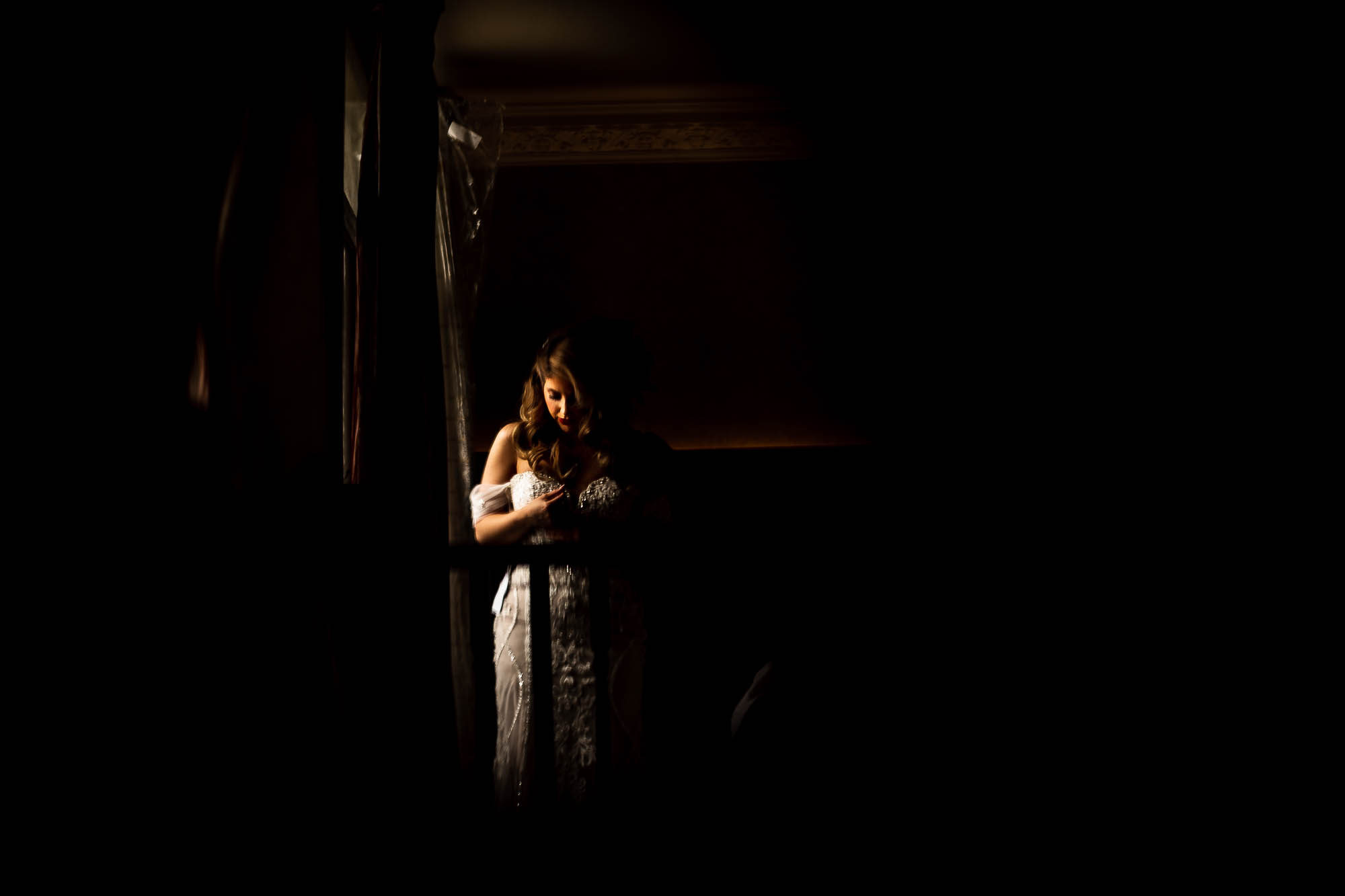 Bride being helped into her wedding dress