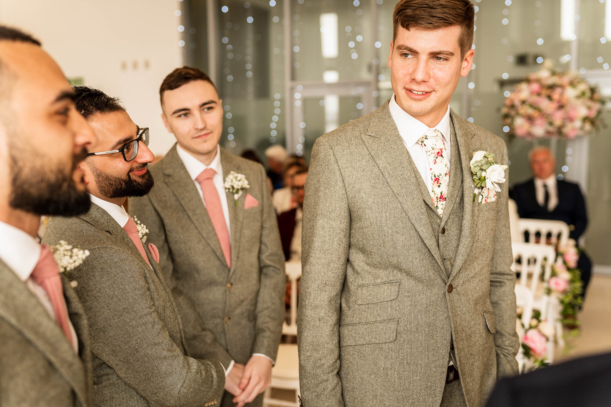 Groom waits for his bride with his groomsmen