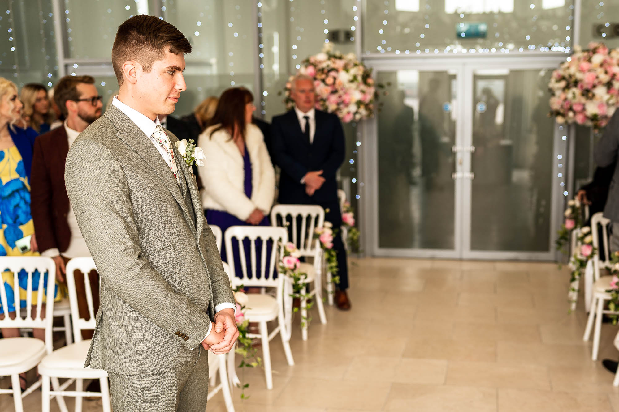 Groom waits just before the bride walks up the aisle.