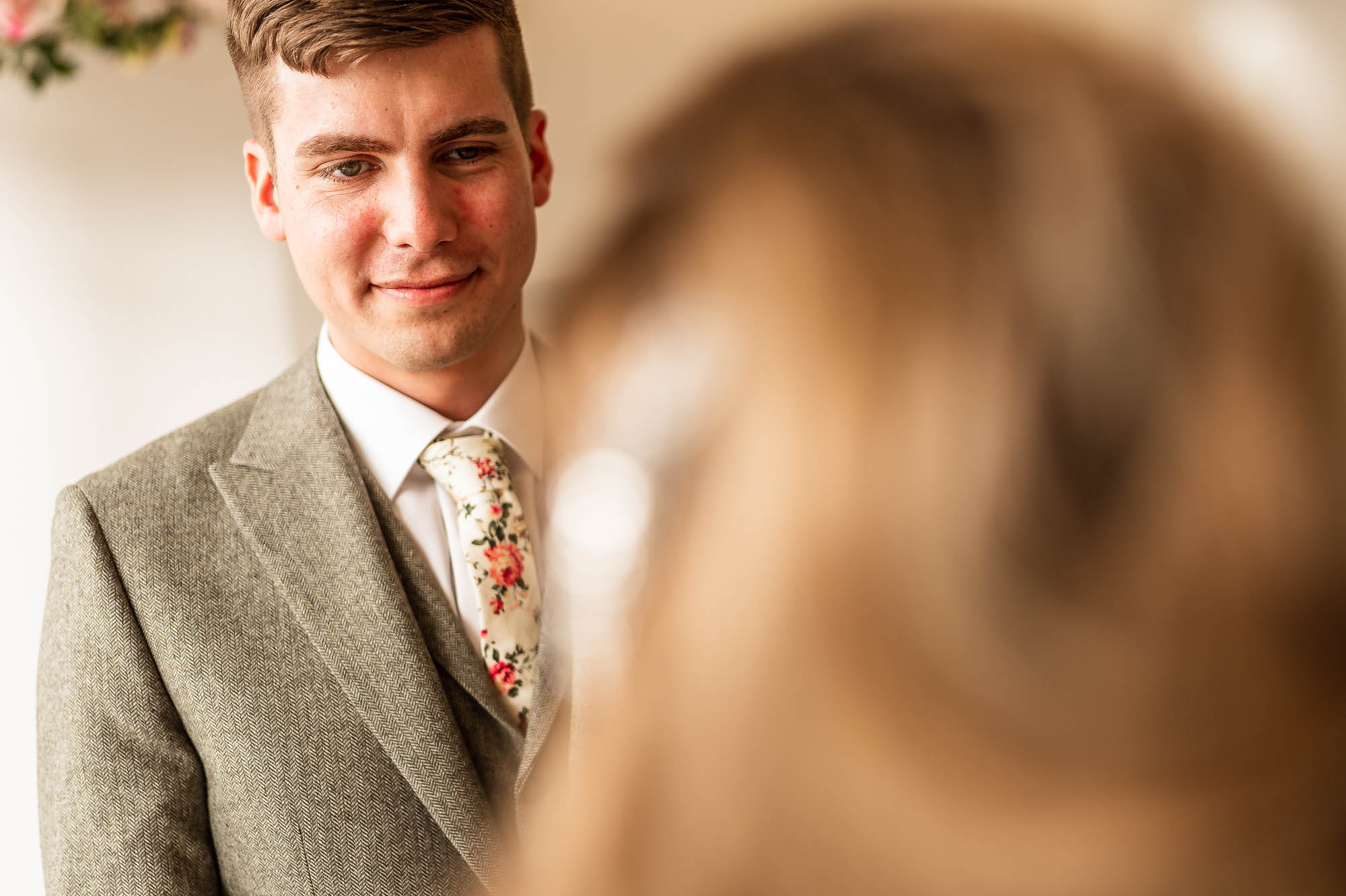 Groom smiles at the 